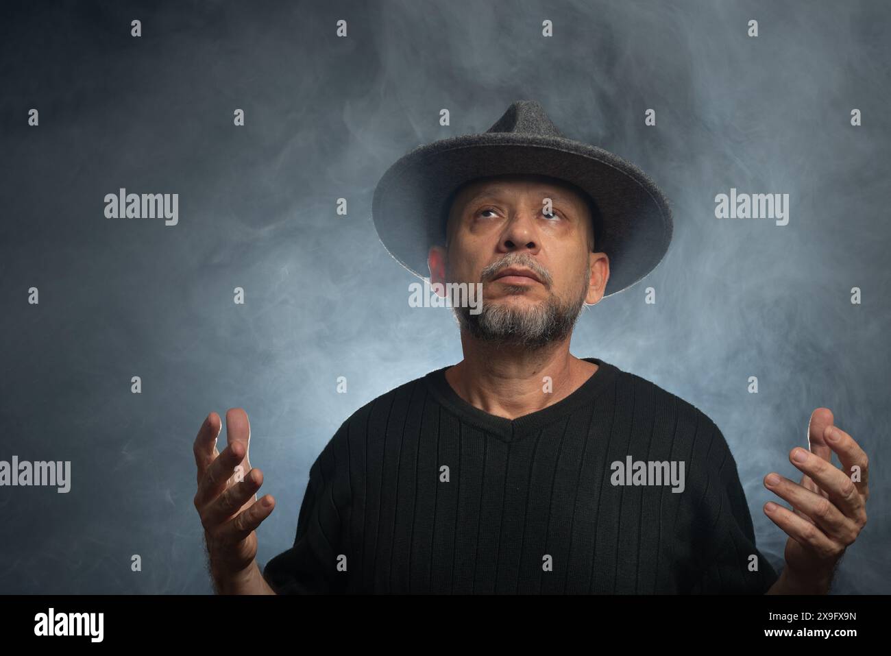Portrait of man with beard and sunglasses and hat posing for ...