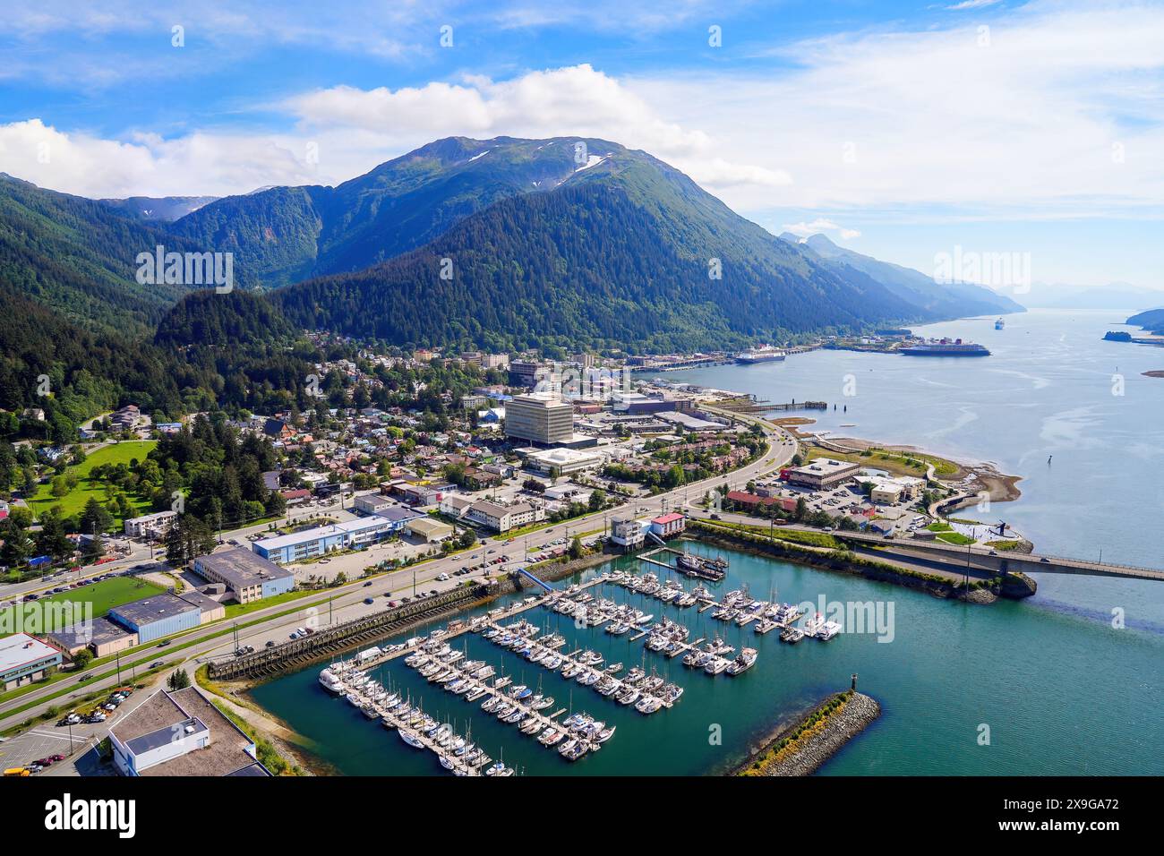 Aerial view of the downtown Juneau, the state capital of Alaska, USA, along the Gastineau Channel in the Arctic - Harris Harbor towered by Alaskan sum Stock Photo