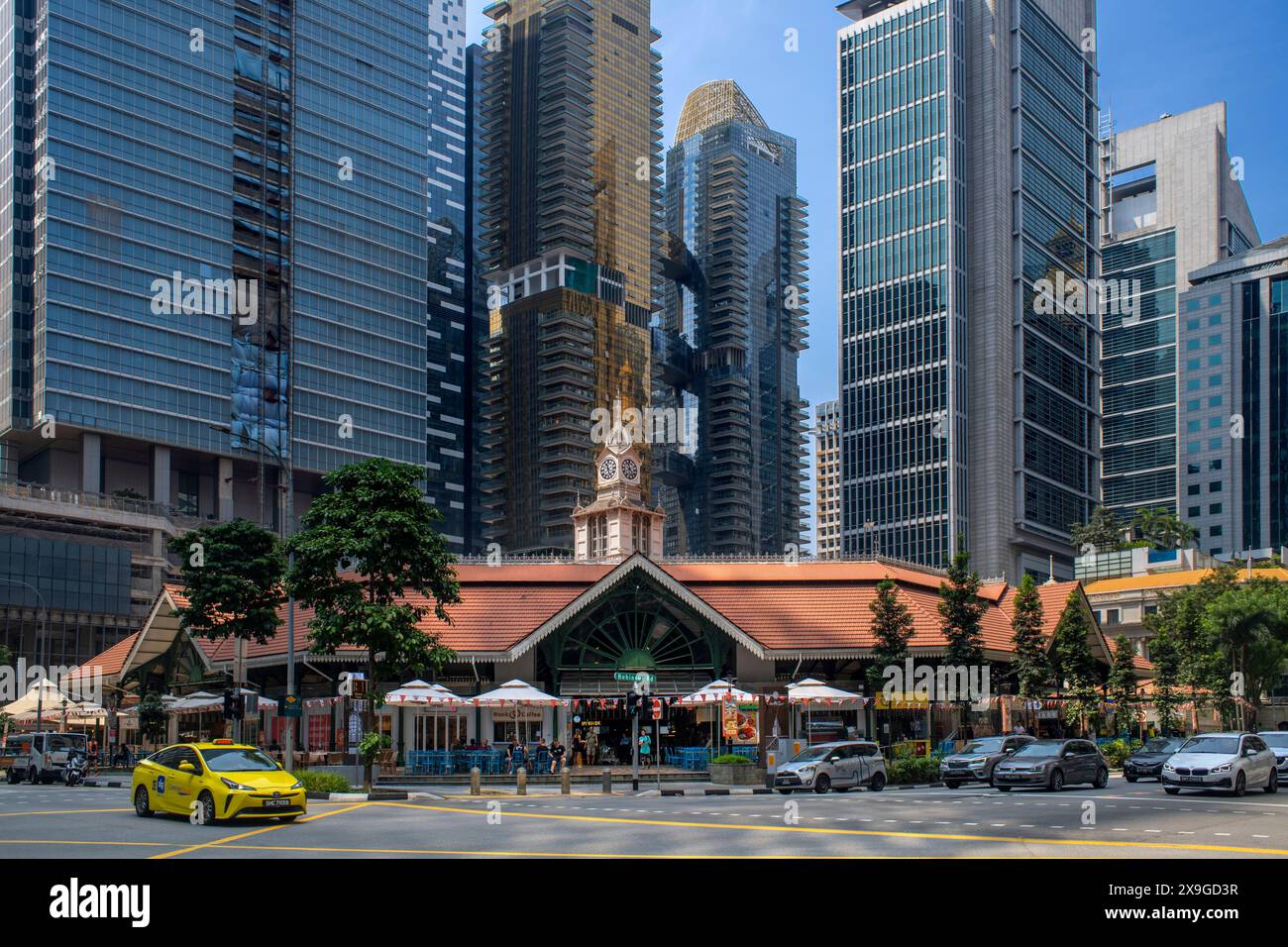 High rise apartments and office skyscrapers towering over Lau Pa Sat food market on Raffles Quay downtown Singapore Stock Photo