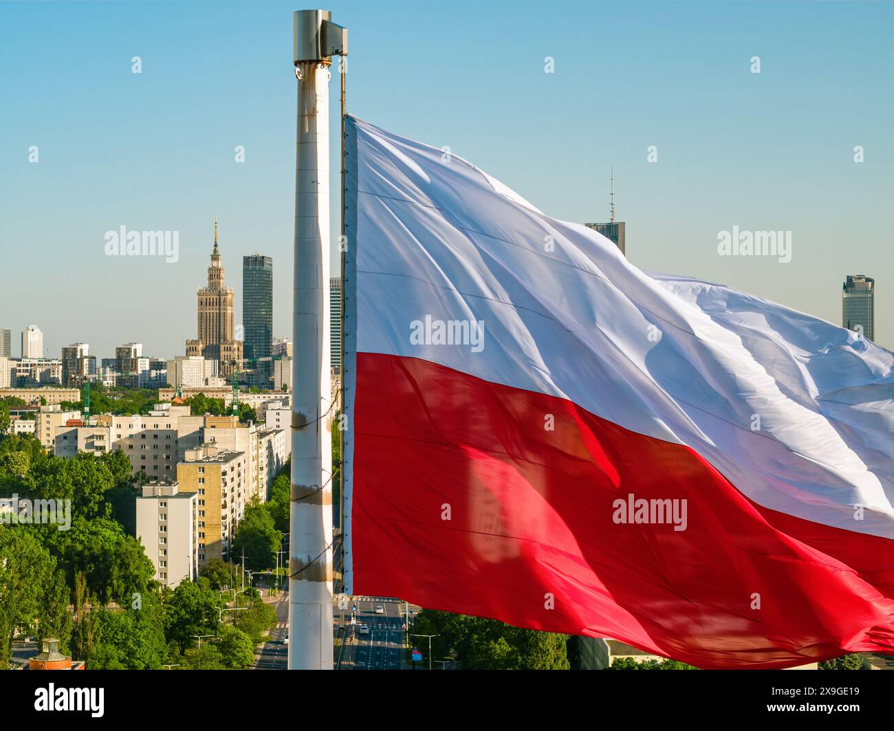 Polish national white and red flag against skyscrapers in Warsaw city ...