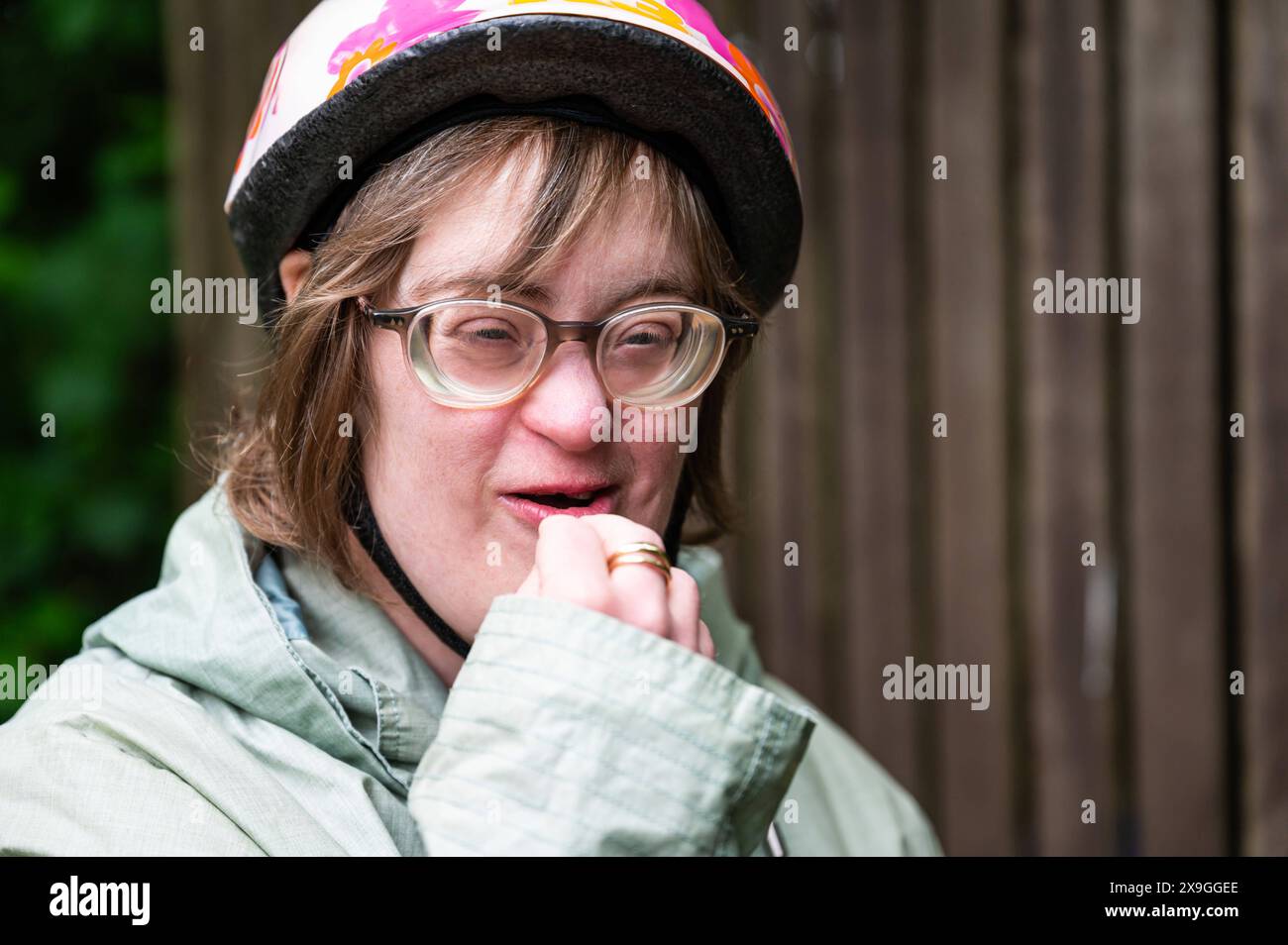 Outdoor portrait of a 41 yo woman with the Down Syndrome wearing a