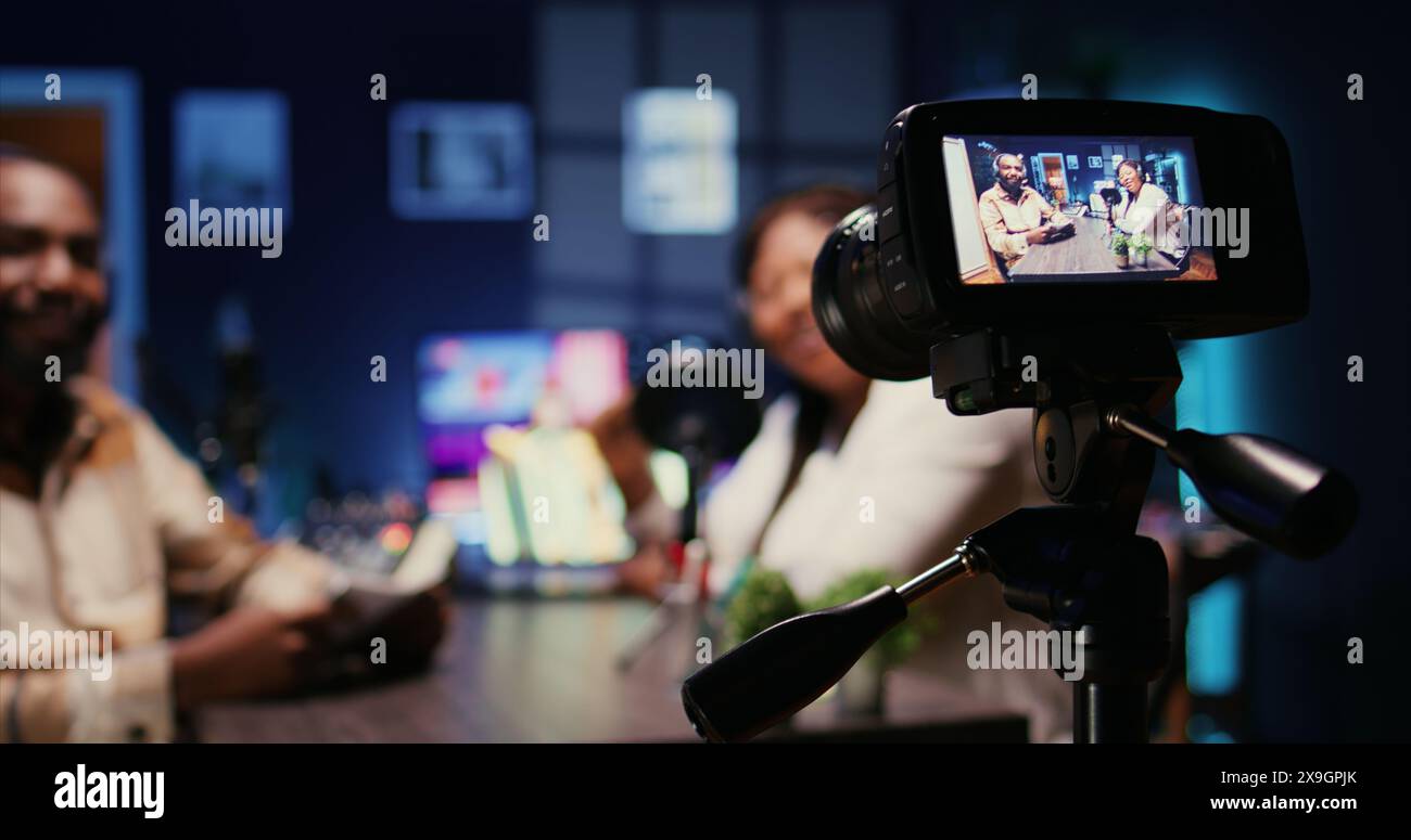 Focus on camera recording man on podcast in blurry background talking ...