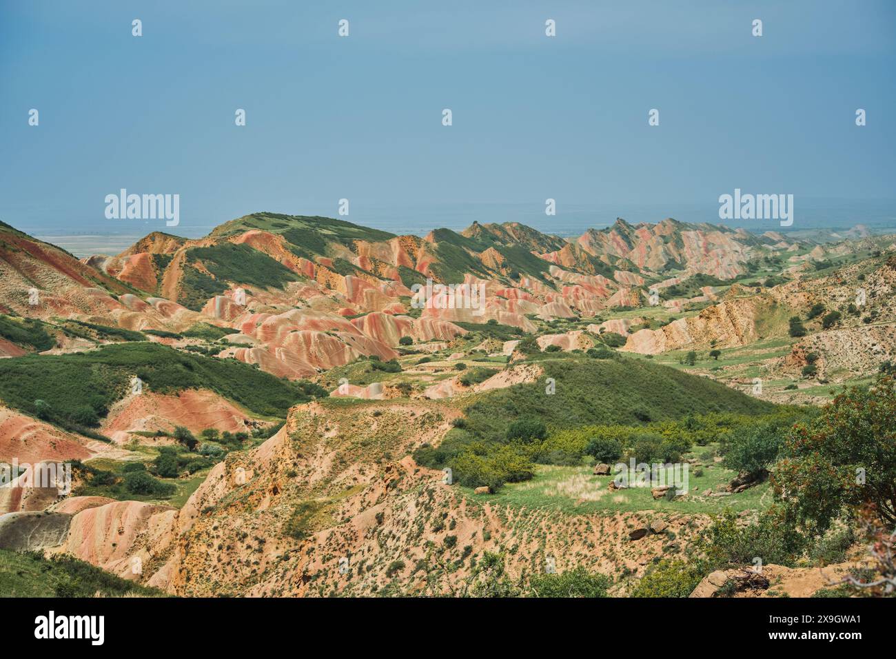 A valley of red hills against a bottomless blue sky, a majestic landscape and an invitation to travel. The unique landscape offers stunning visual con Stock Photo