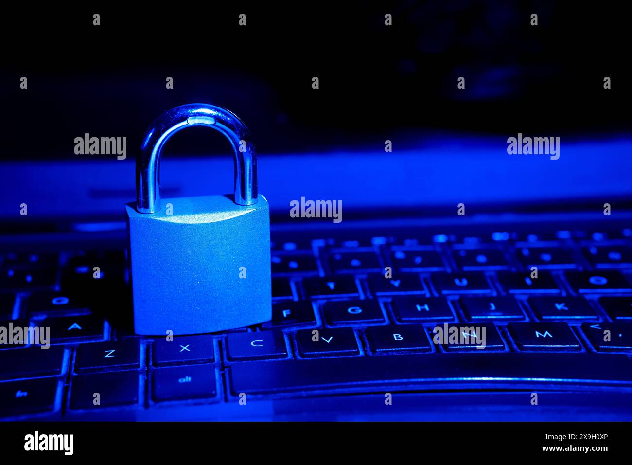 Cybersecurity concept, padlock on laptop computer keyboard Stock Photo