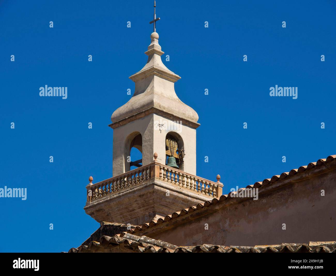 bell-tower-of-a-historic-church-building-with-bell-under-a-clear-blue