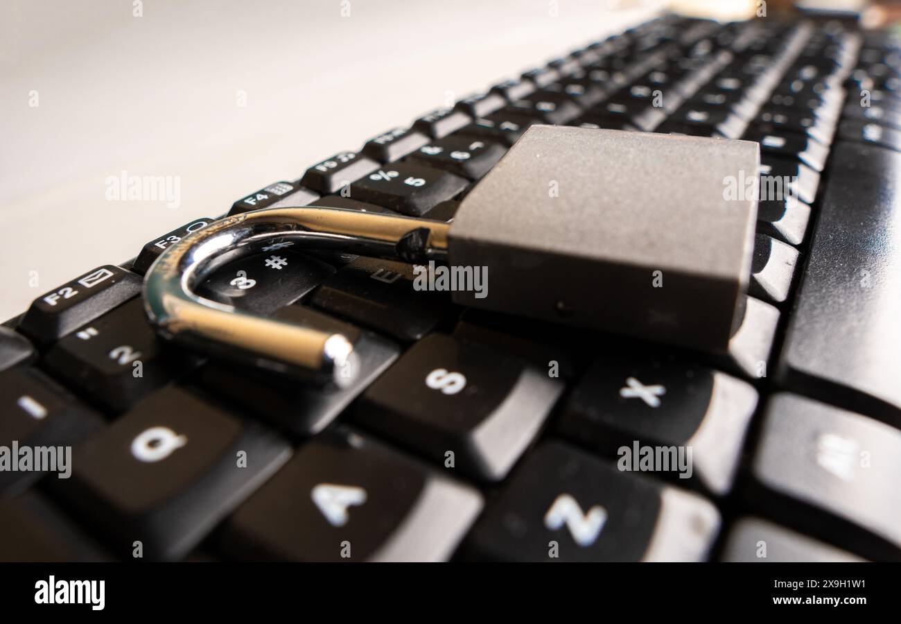 Close up to An open padlock on a computer keyboard Stock Photo