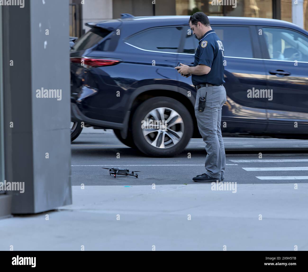 Brooklyn, NY - May 31 2024: NYPD officer flies drone during pro Palestine protest near Brooklyn Museum on Eastern Parkway, Brooklyn, New York City. Stock Photo