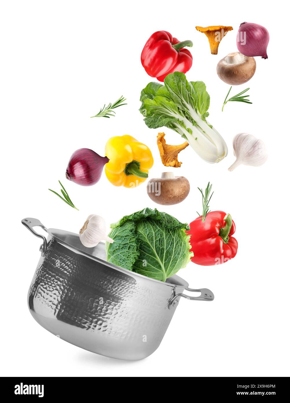 Fresh ingredients falling into saucepan on white background Stock Photo
