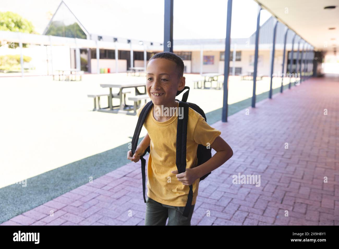 Biracial boy smiles at school, with copy space Stock Photo - Alamy