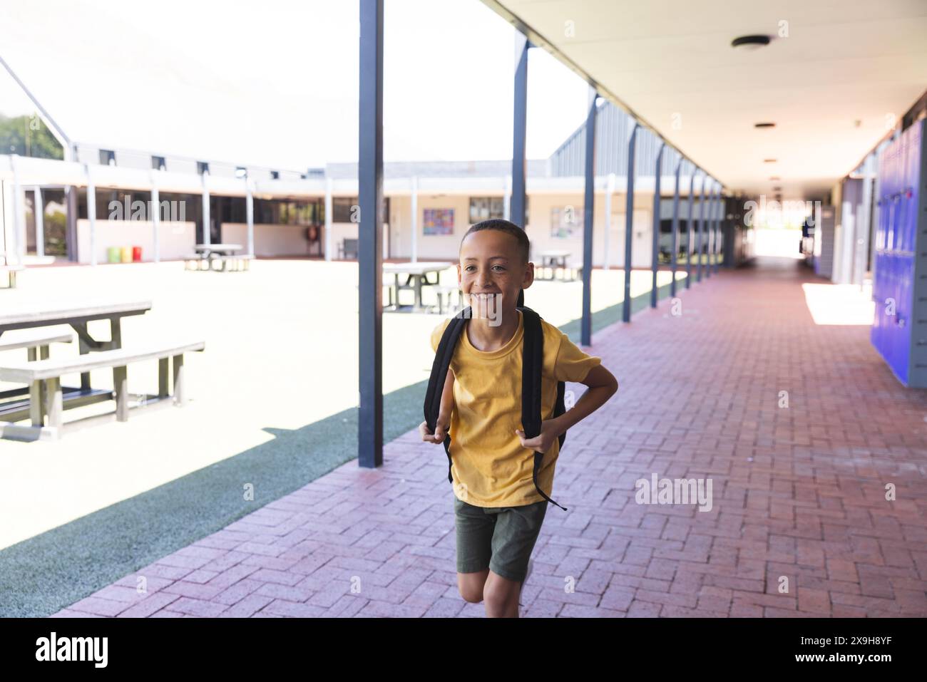 Biracial boy smiles brightly at school Stock Photo - Alamy