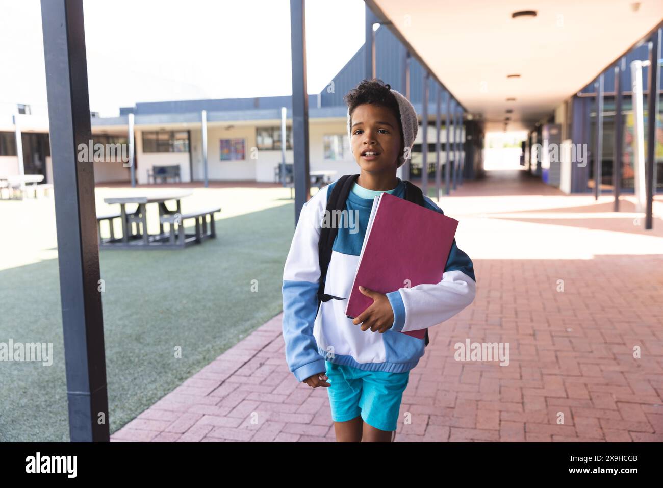 Biracial boy stands confidently at school Stock Photo - Alamy