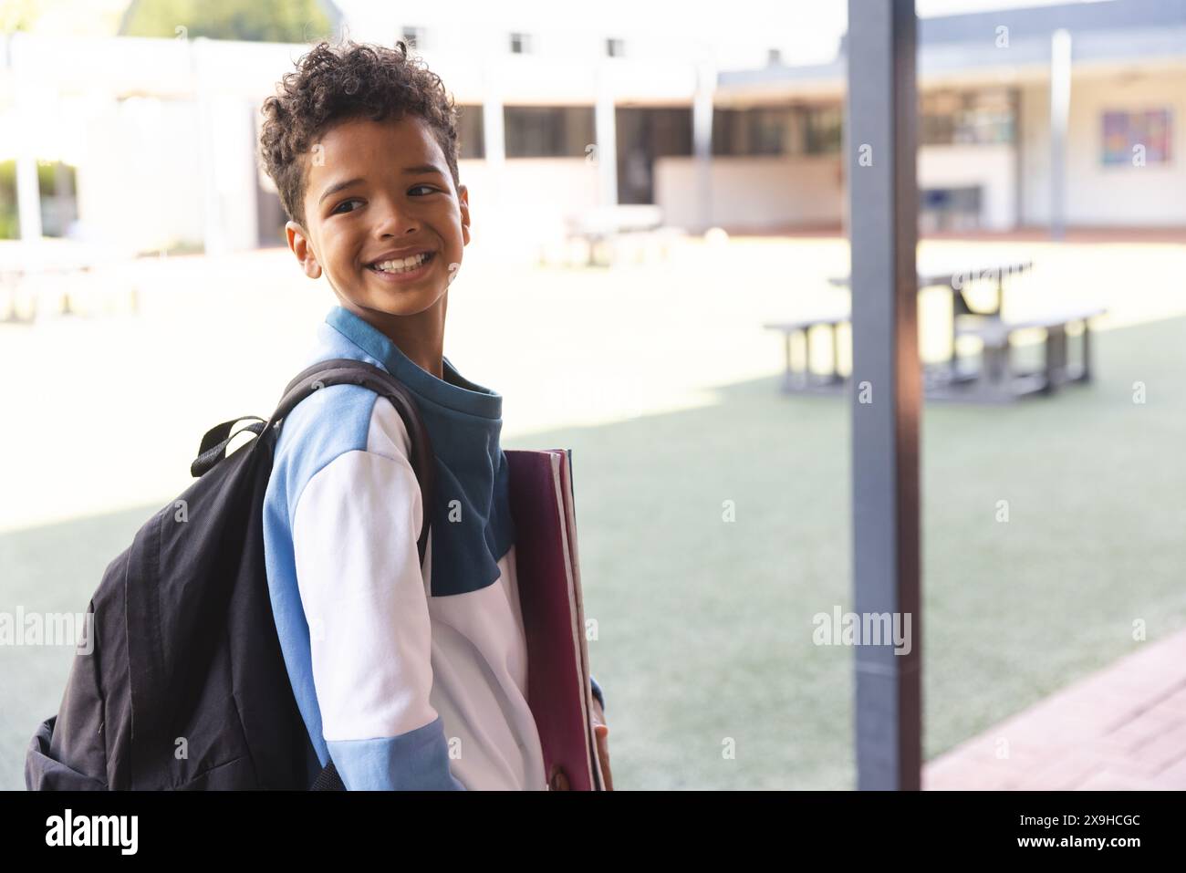 Biracial boy smiles at school, with copy space Stock Photo - Alamy
