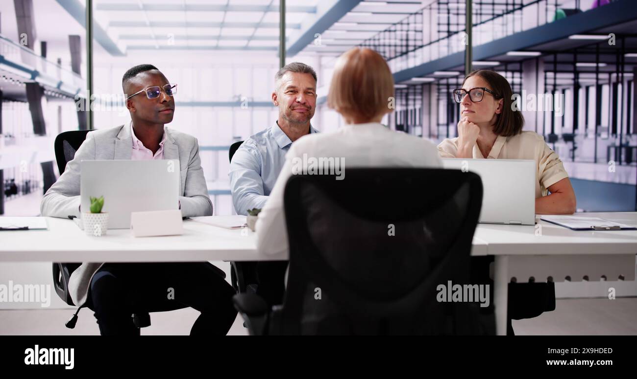 Young Woman Sitting At Interview In Office Stock Photo