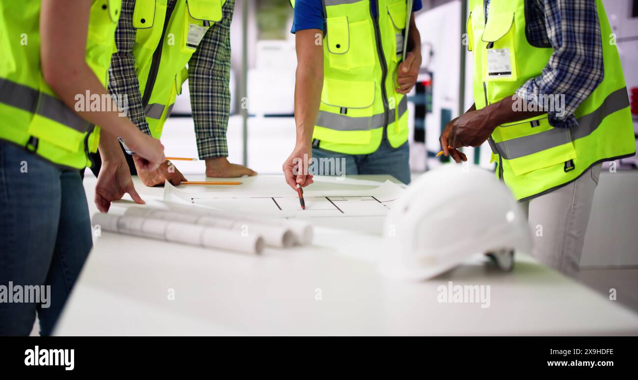 Civil Engineer Or Architect Team With Construction Plans Stock Photo