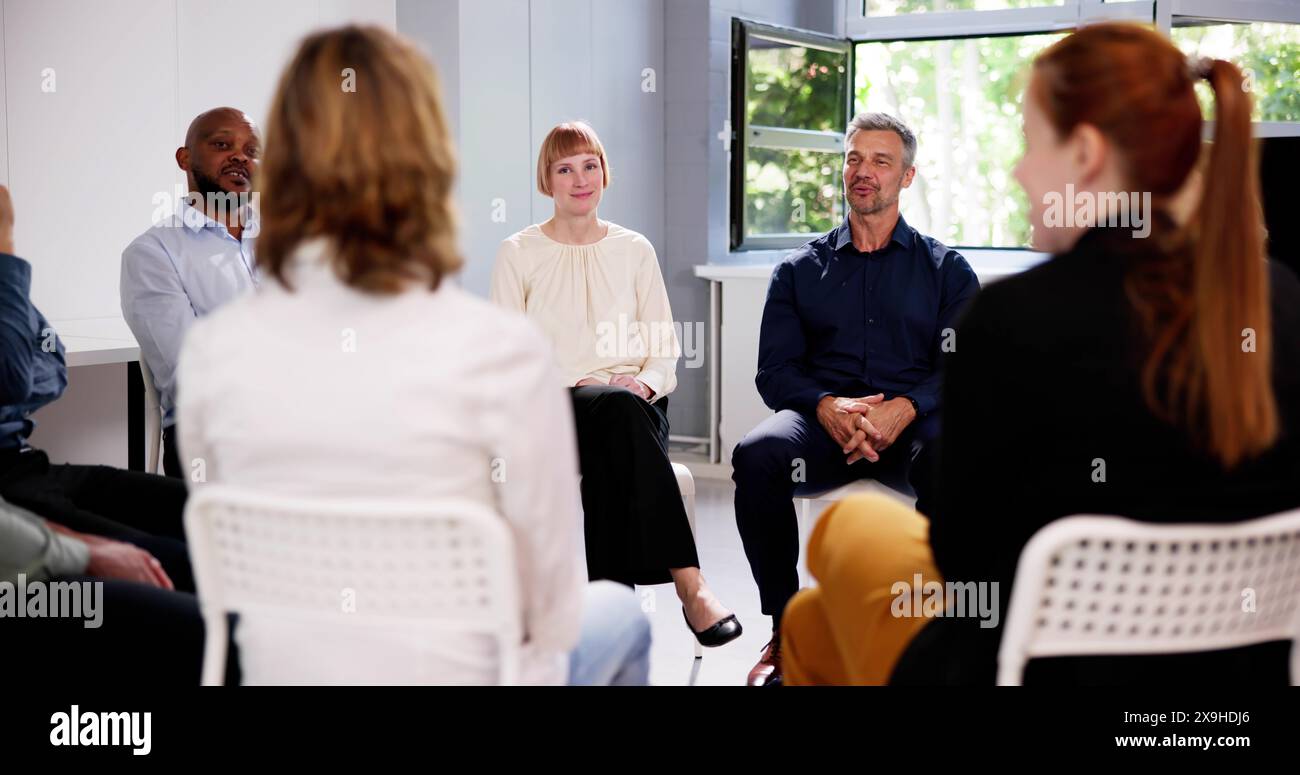 People Consoling Man In Group Therapy Session Stock Photo