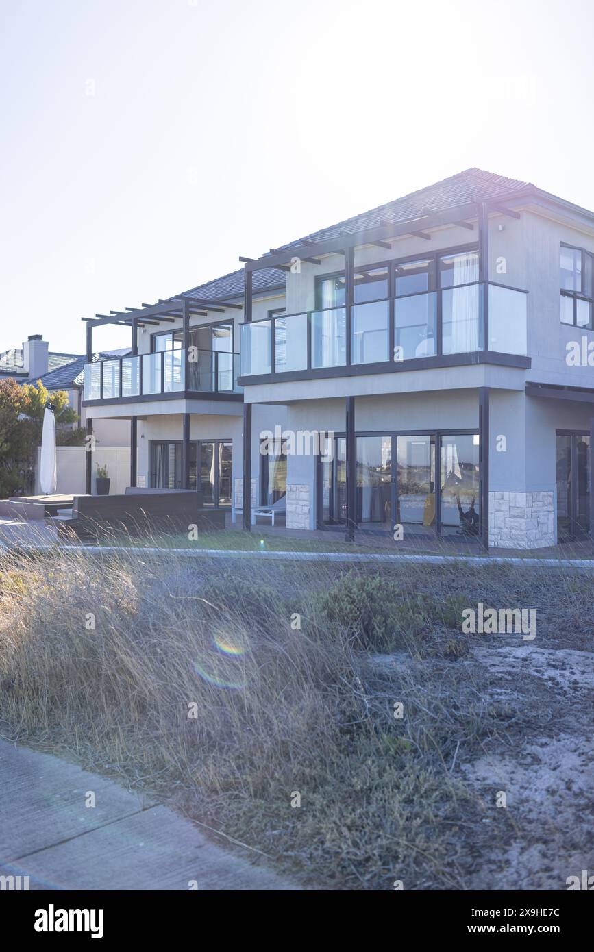 Outdoors, modern house with glass windows overlooking beach Stock Photo