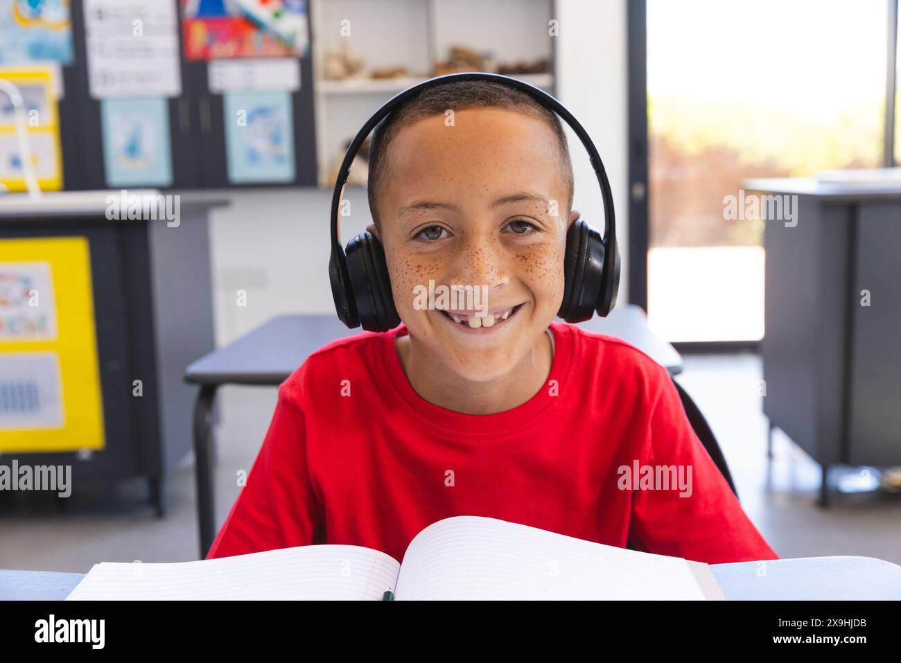 Biracial boy studies in a classroom at school on a video call Stock ...
