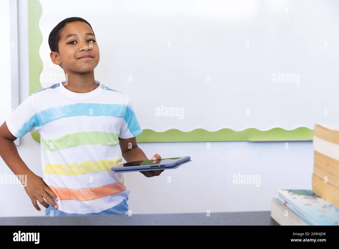 Biracial boy in a classroom at school, with copy space Stock Photo - Alamy