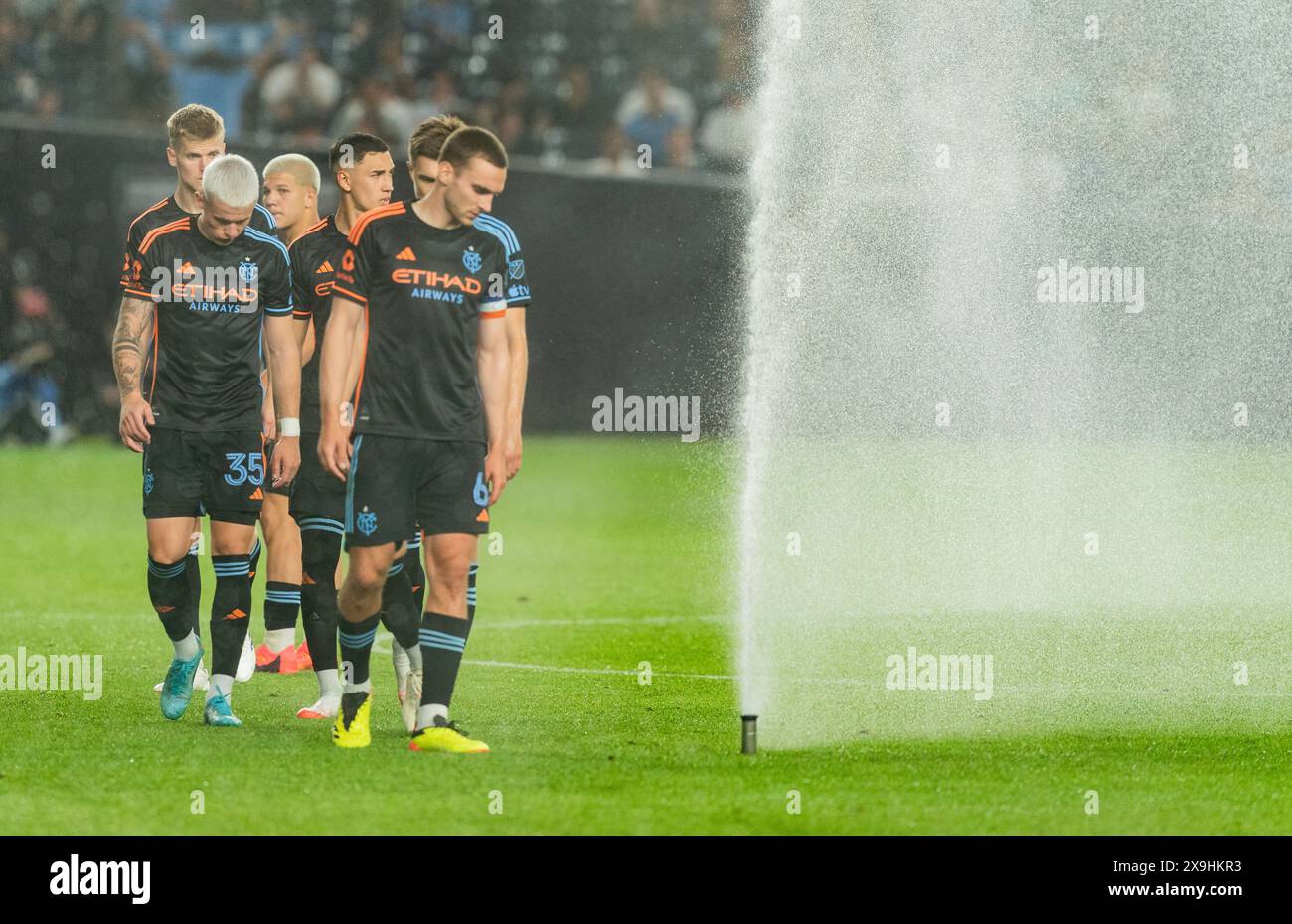 Players of NYCFC walk on the pitch as it was watered during MLS regular game against San Jose Earthquakes at Yankee stadium in New York on May 31, 2024. NYCFC won 5 - 1 Stock Photo