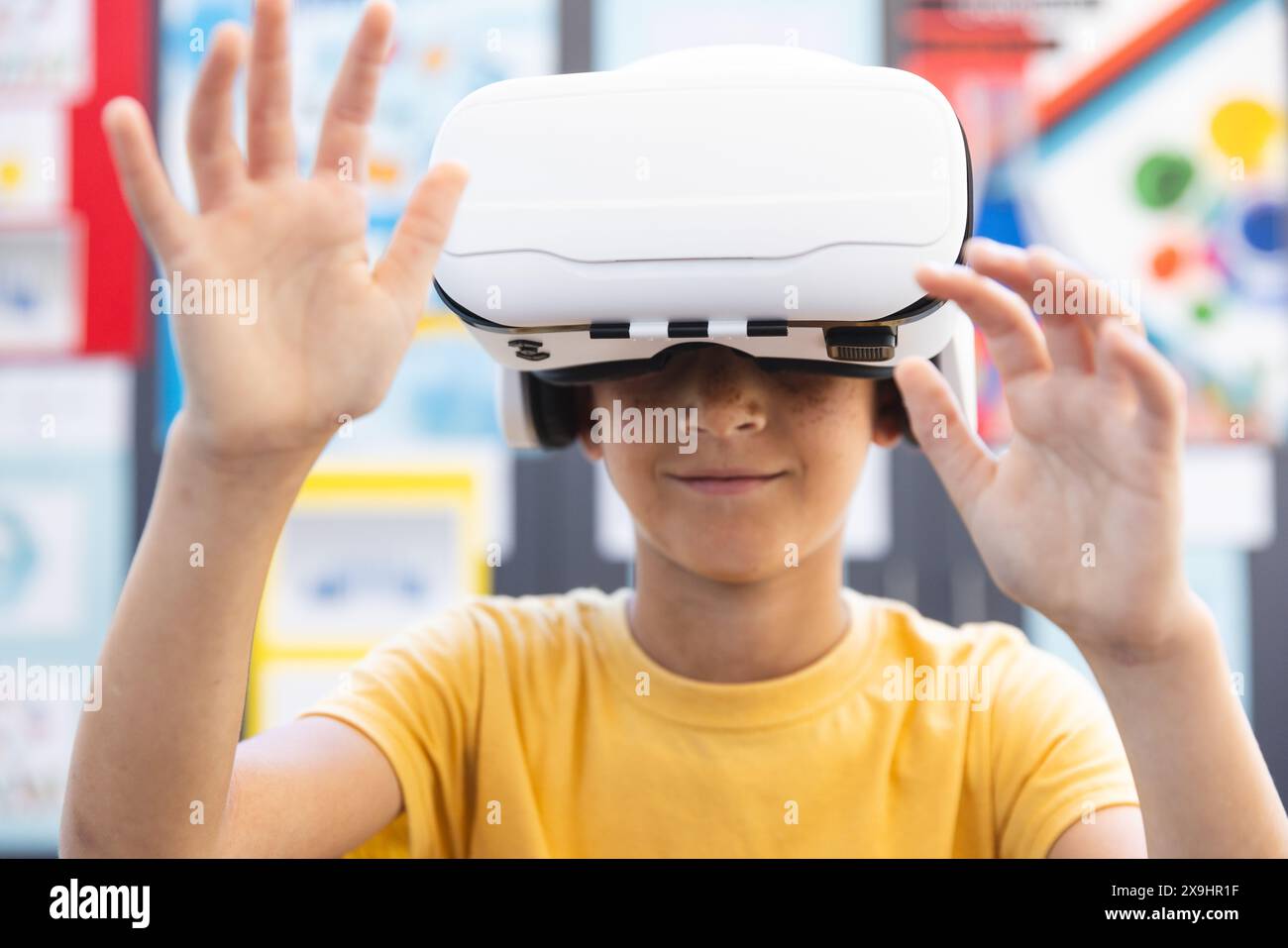 Biracial boy explores virtual reality at school Stock Photo
