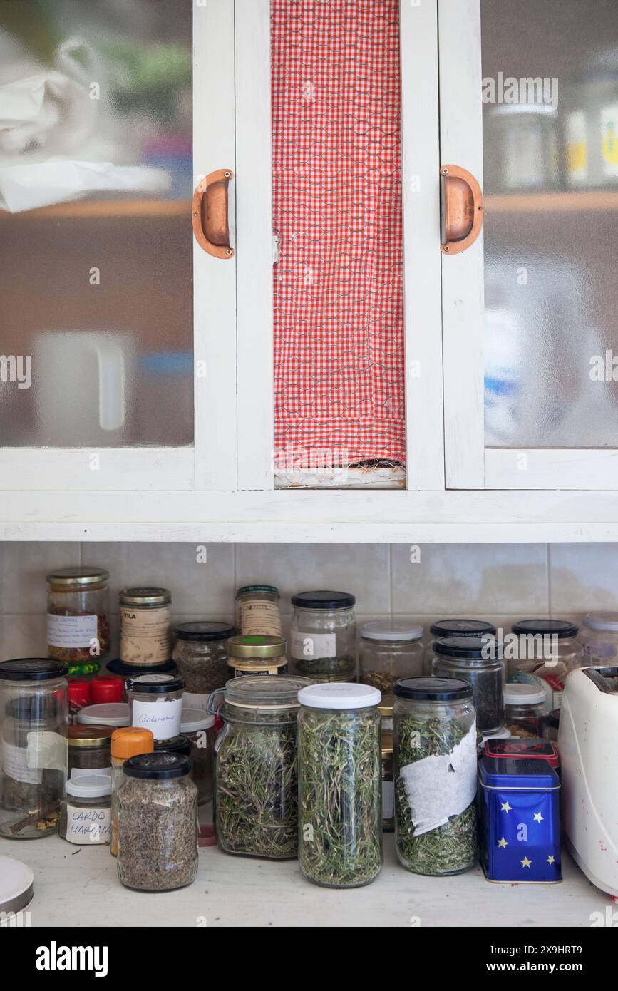 Cupboard full of glass jars with natural home remedies. Closseup Stock ...