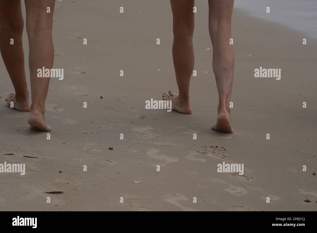 Feet barefoot walking on the sand beach Stock Photo