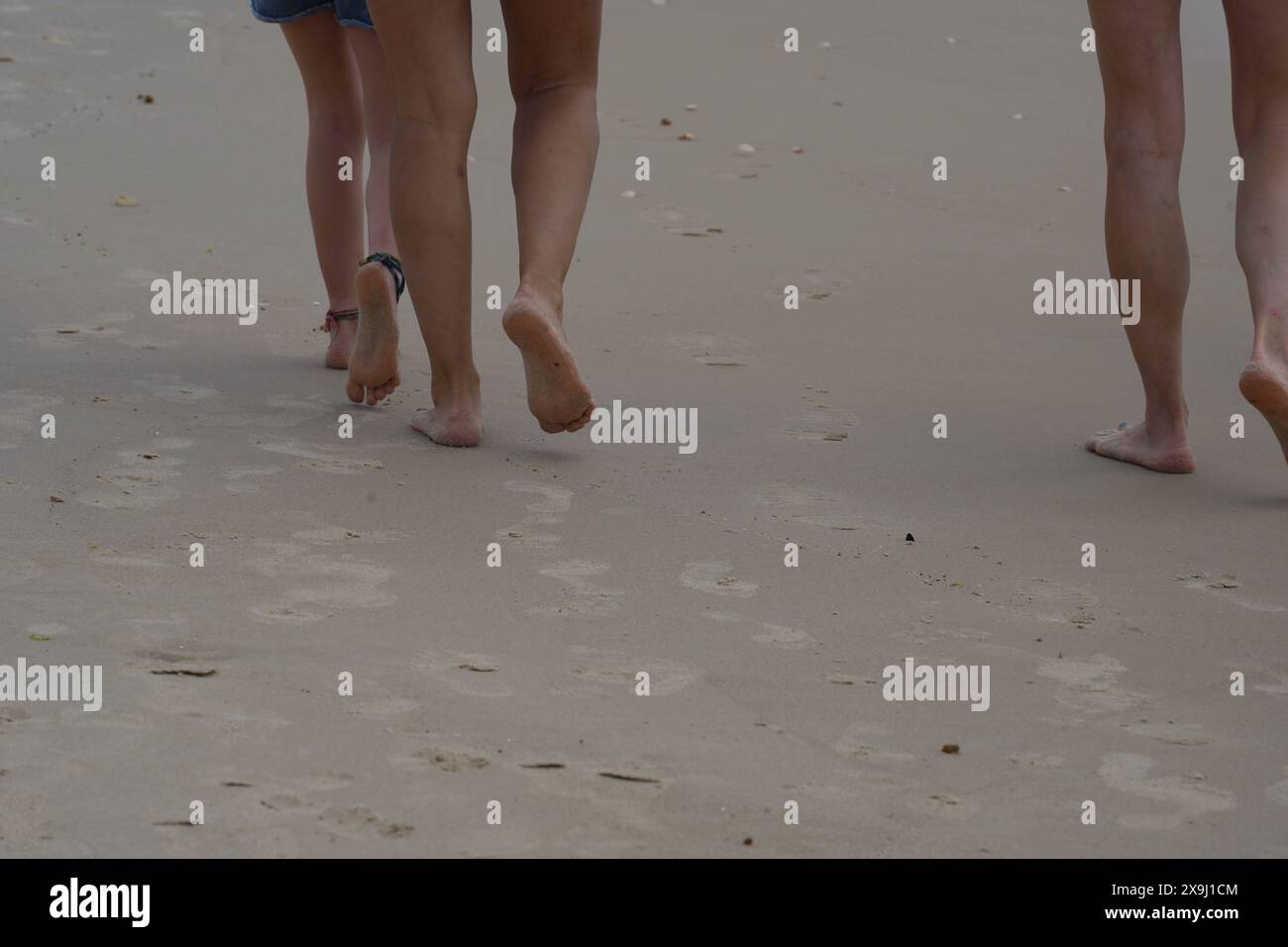 Feet barefoot walking on the sand beach Stock Photo