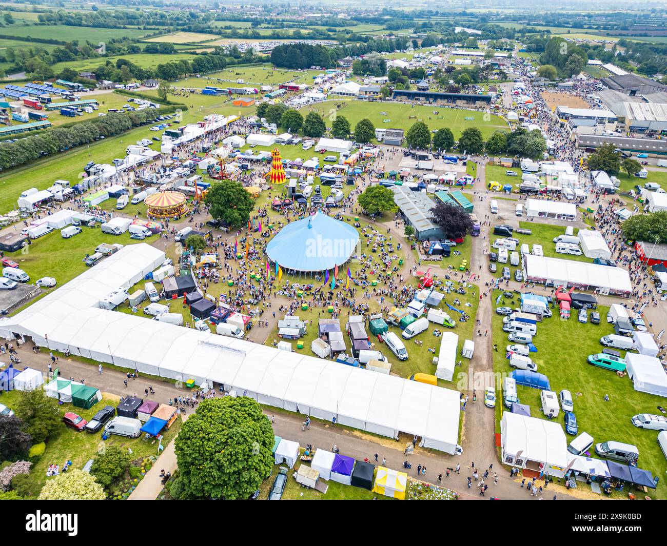 SHEPTON MALLET, SOMERSET, UK, 1st June, 2024, Aerial Drone high level shot from above showing the crowds and action at the Royal Bath and West Show 2024. Credit John Rose/Alamy Live News Stock Photo