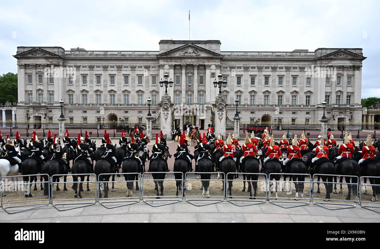 London, UK. 1st June, 2024. The Major General’s Review of the Trooping of the Colour for the King’s Birthday Parade takes place. This rehearsal is the first of two formal reviews in full dress uniform of the troops and horses before parading for HM The King’s Official Birthday Parade on the 15th June. The soldiers are inspected by Major General James Bowder OBE, The Major General Commanding the Household Division. Image: Mounted Household Cavalry line up outside Buckingham Palace as the King’s carriage arrives back from the Trooping of the Colour ceremony at Horse Guards Parade. Credit: Malcol Stock Photo