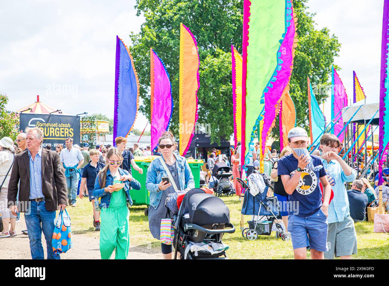 SHEPTON MALLET, SOMERSET, UK, 1st June, 2024,  image showing the crowds having picnics and having fun among the colourful flags and action at the Royal Bath and West Show 2024.   Credit John Rose/Alamy Live News Stock Photo