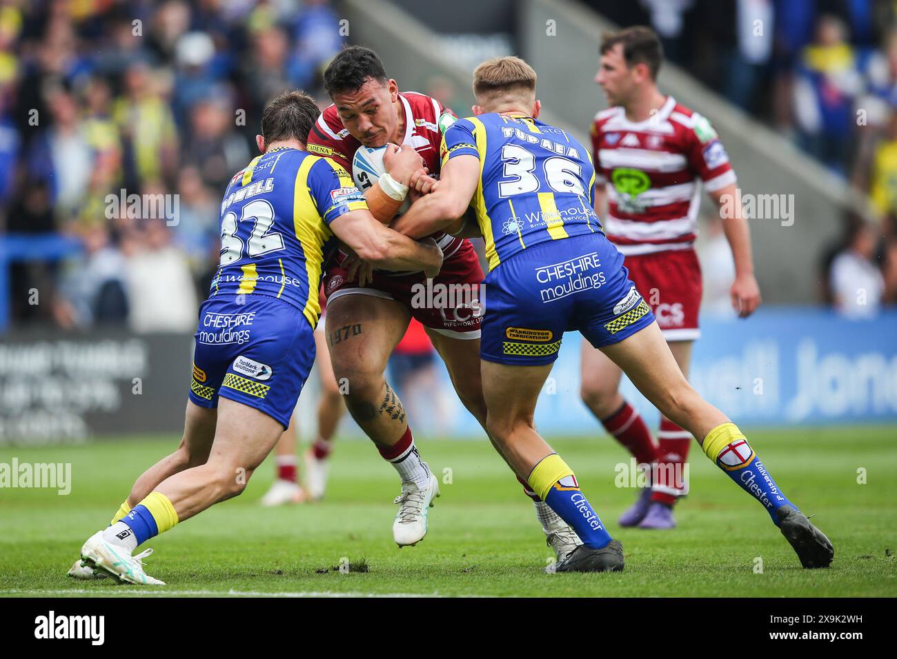 Warrington, UK. 01st June, 2024. Tyler Dupree of Wigan Warriors is tackled by Sam Powell of Warrington Wolves and Nolan Tupaea of Warrington Wolves during the Betfred Super League Round 13 match Warrington Wolves vs Wigan Warriors at Halliwell Jones Stadium, Warrington, United Kingdom, 1st June 2024 (Photo by Gareth Evans/News Images) in Warrington, United Kingdom on 6/1/2024. (Photo by Gareth Evans/News Images/Sipa USA) Credit: Sipa USA/Alamy Live News Stock Photo