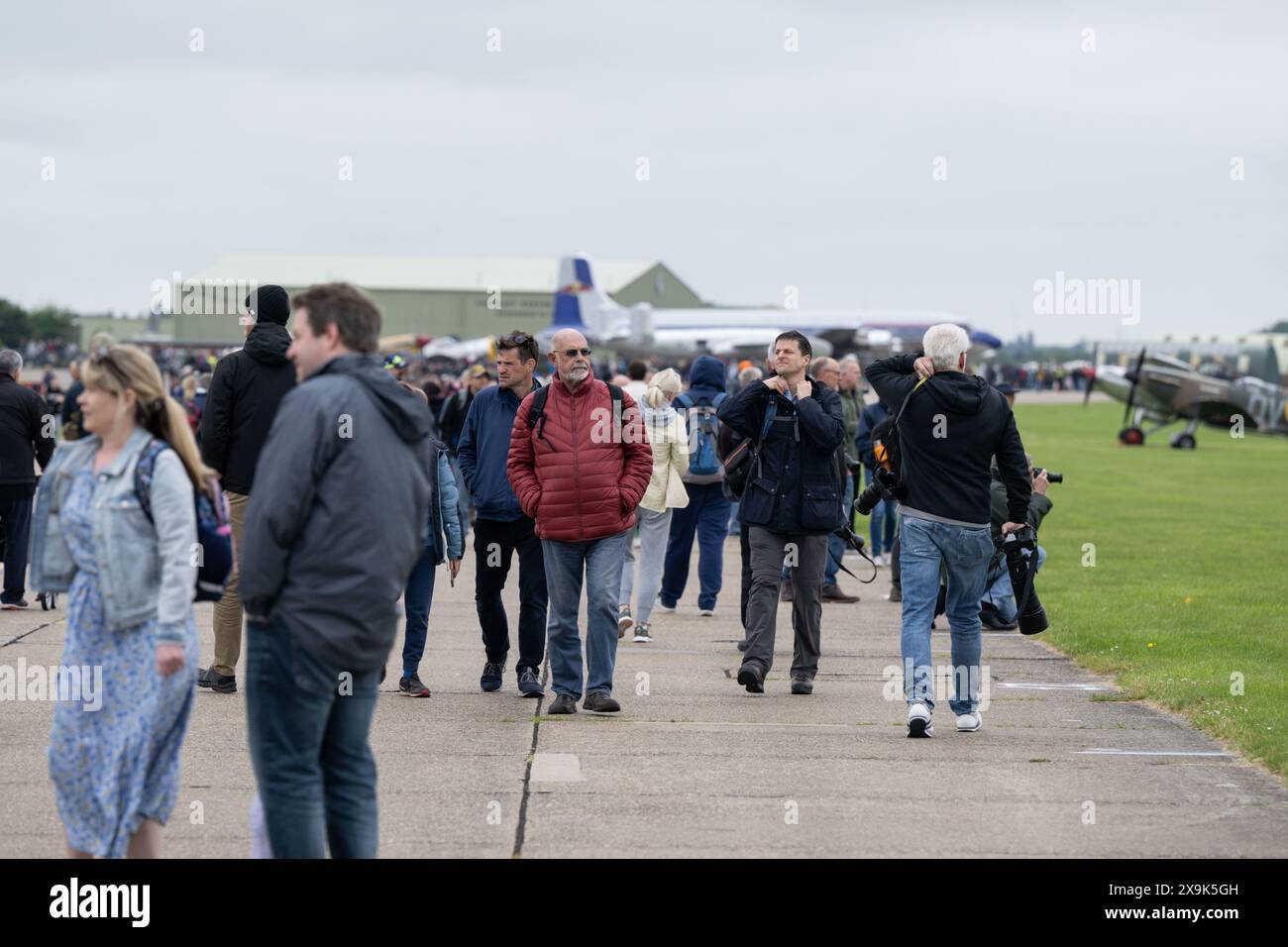 Visiting spectators take in the airfield ahead of, the Duxford Summer