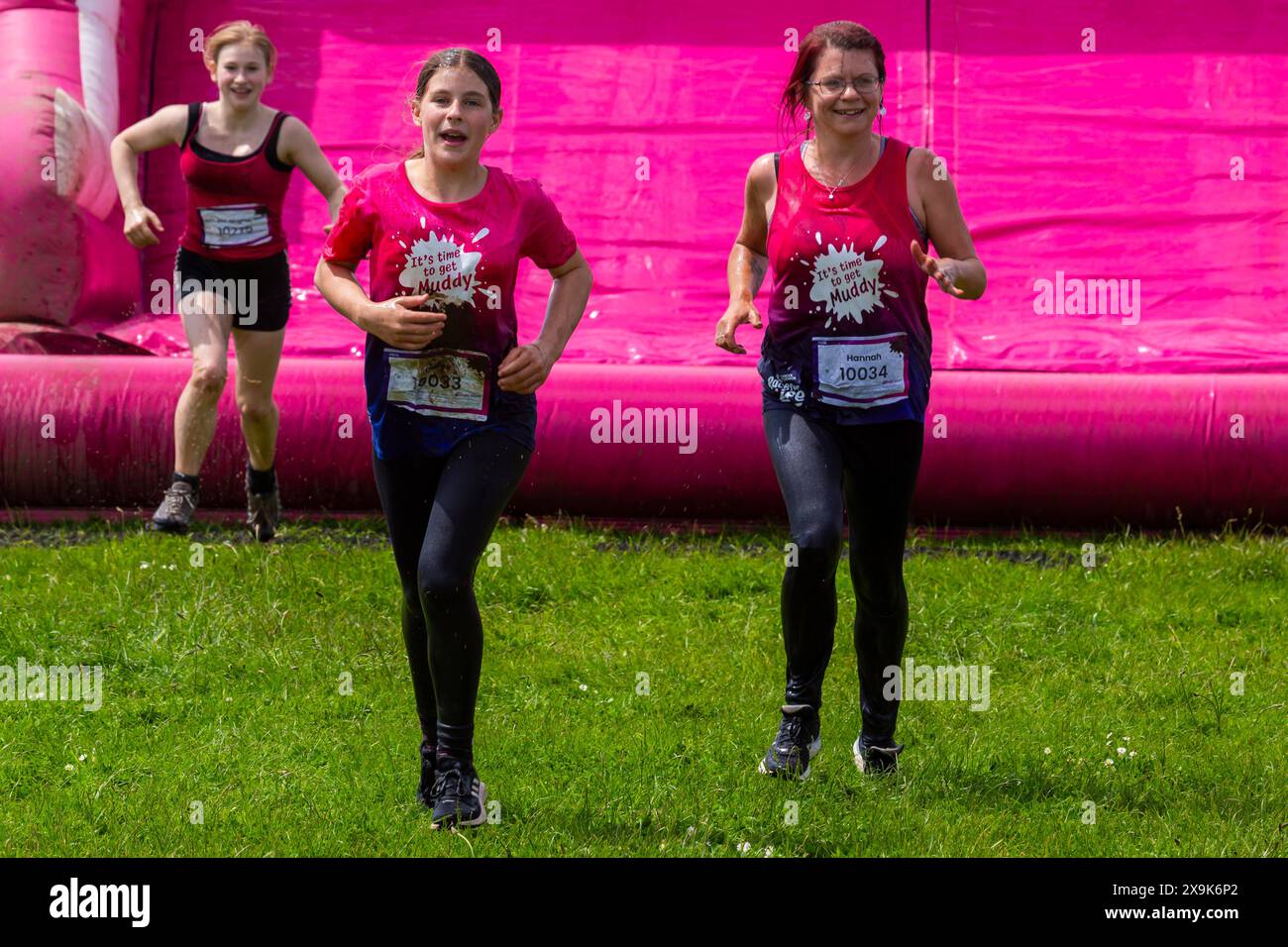 Baiter Park, Poole, Dorset, UK. 1st June 2024. Sunny intervals with a cool breeze for Race for Life Poole Pretty Muddy with hundreds, many dressed in pink, joining the fight to beat cancer and raise money for Cancer Research UK, negotiating obstacles and having fun getting covered in mud, both in the kids race and adults. Credit: Carolyn Jenkins/Alamy Live News Stock Photo