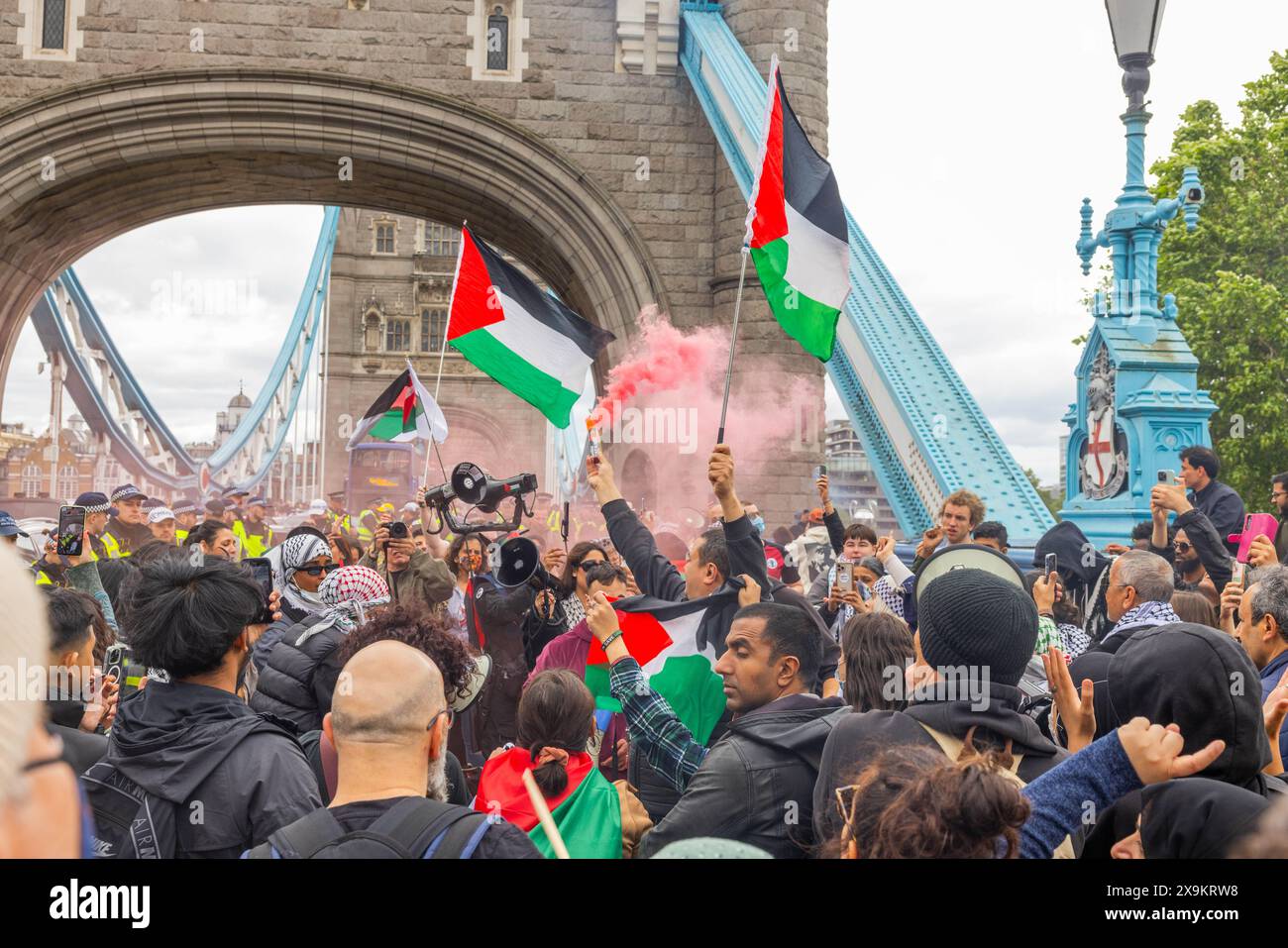 London, UK. 01 JUN, 2024. Pro Palestine protestors gather with smoke bombs on a section of the right-hand side pathway of the Tower Bridge. Credit Milo Chandler/Alamy Live News Stock Photo