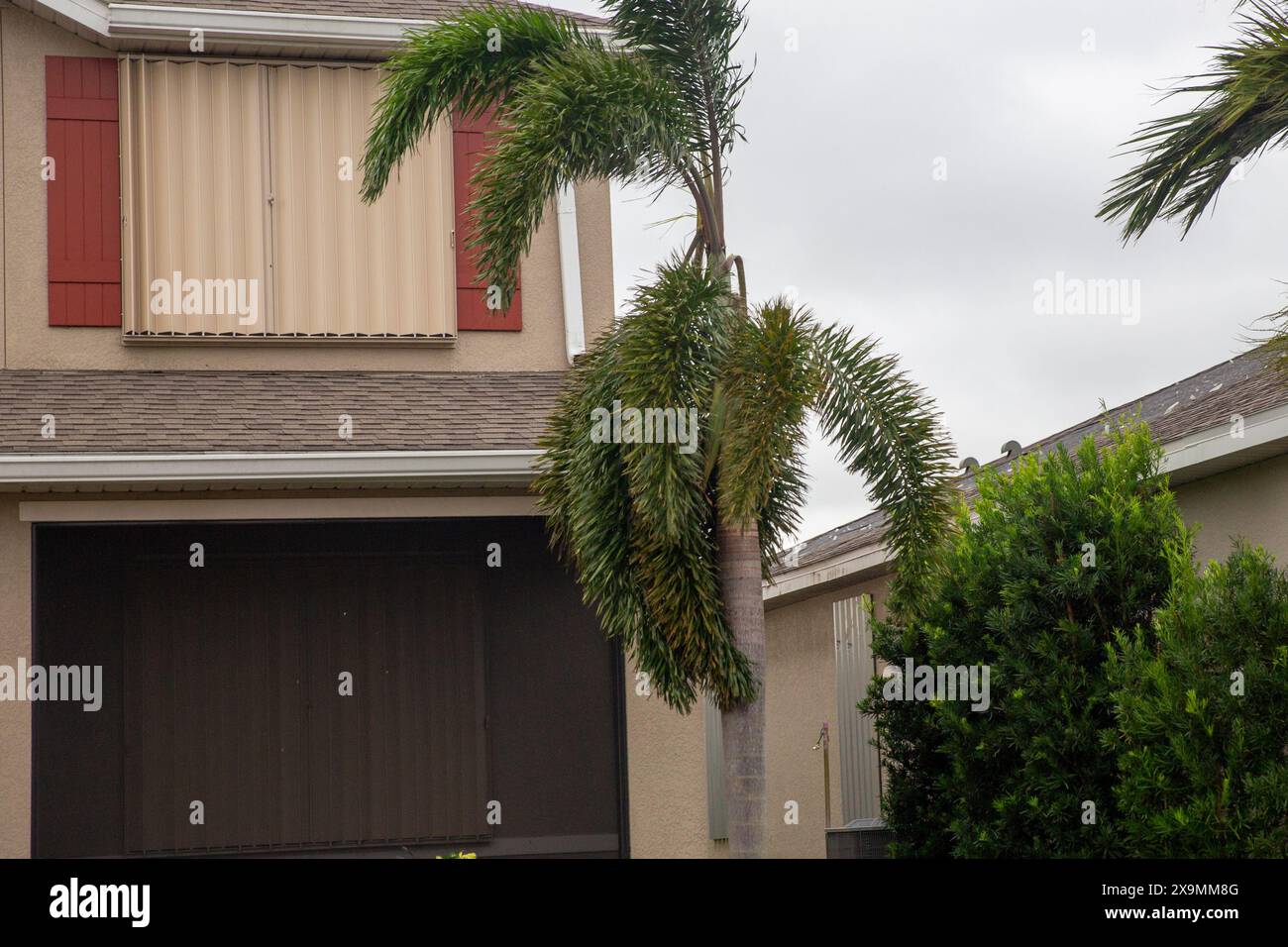 House prepared for a hurricane with shutters up Stock Photo