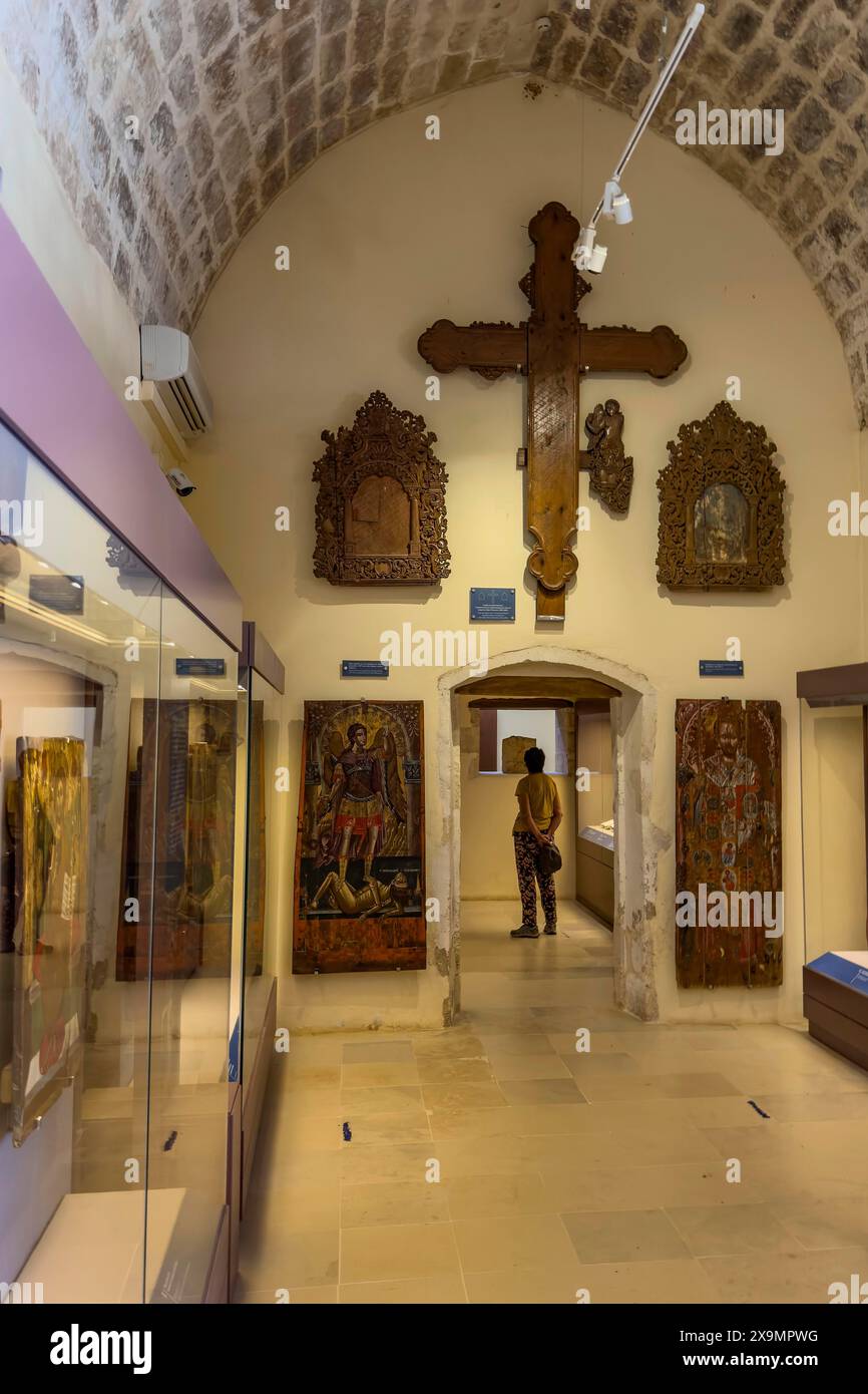 Entrance area with showcases and large wooden cross on wall in vaulted museum Monastery museum in UNESCO World Heritage Site orthodox monastery Moni Stock Photo