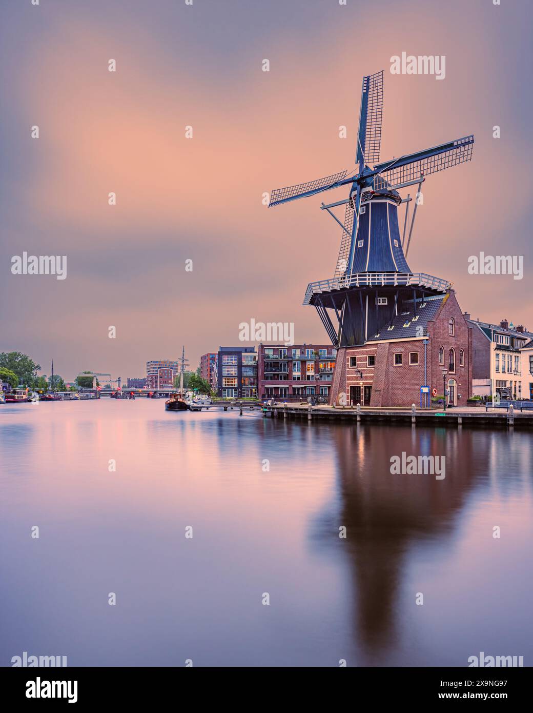 A vertical 4:5 image from an evening at sunset at Mill de Adriaan. built in 1779 as a Tras Mill, then as a Tobacco Mill and Flour Mill, before finally Stock Photo