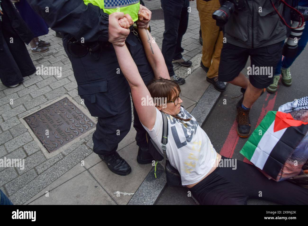London, UK. 1st June 2024. A police officer drags a protester blocking York Road near Waterloo Station. Activists from the group Youth Demand marched in solidarity with Palestine as Israel continues its attacks on Gaza. Credit: Vuk Valcic/Alamy Live News Stock Photo
