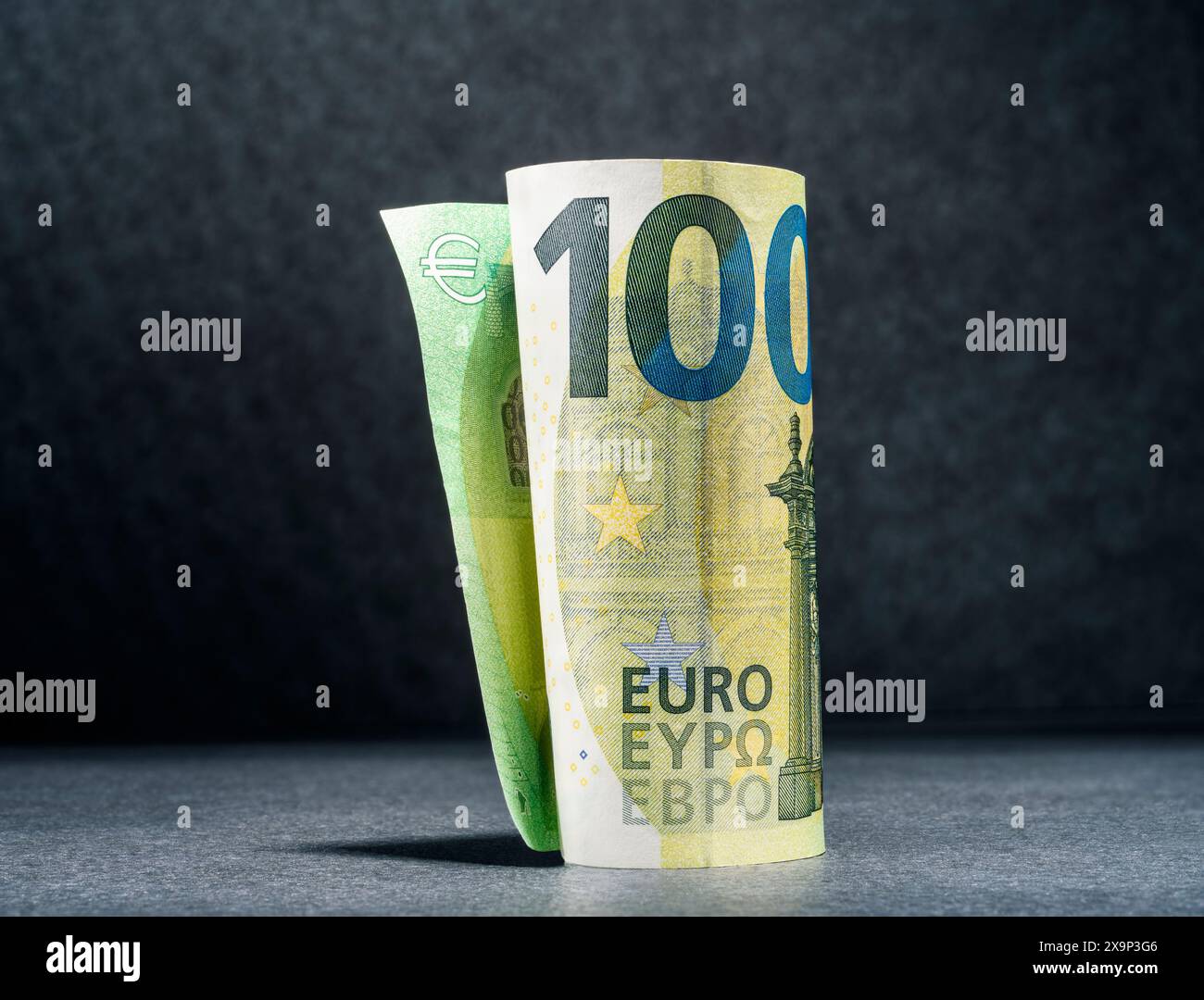 One hundred euro banknote against a dark background Stock Photo - Alamy