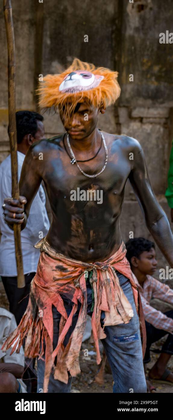 Culturally dressed tribal performer with body paint and a spear ...