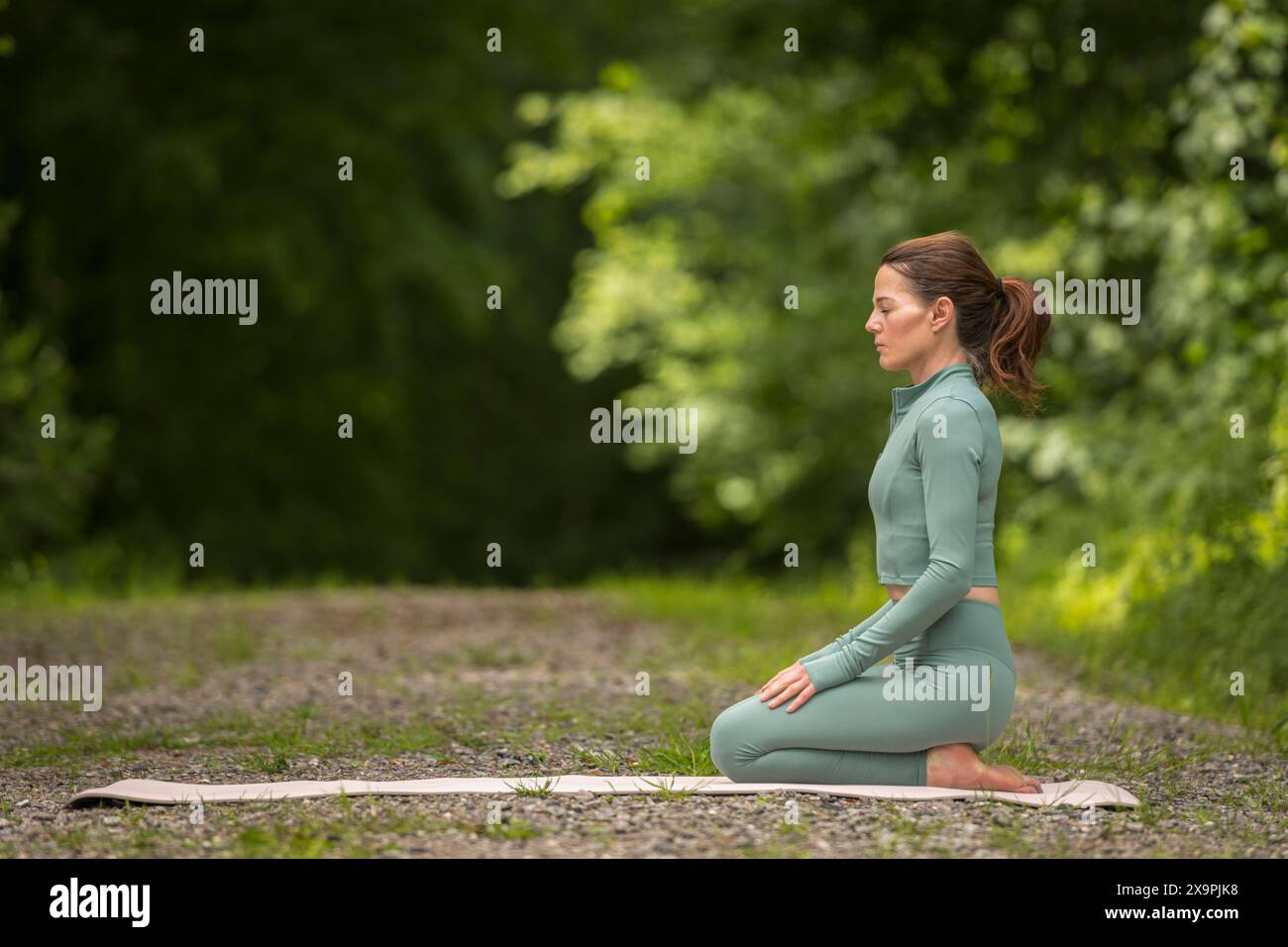 Woman kneeling with eyes closed hi-res stock photography and images - Alamy