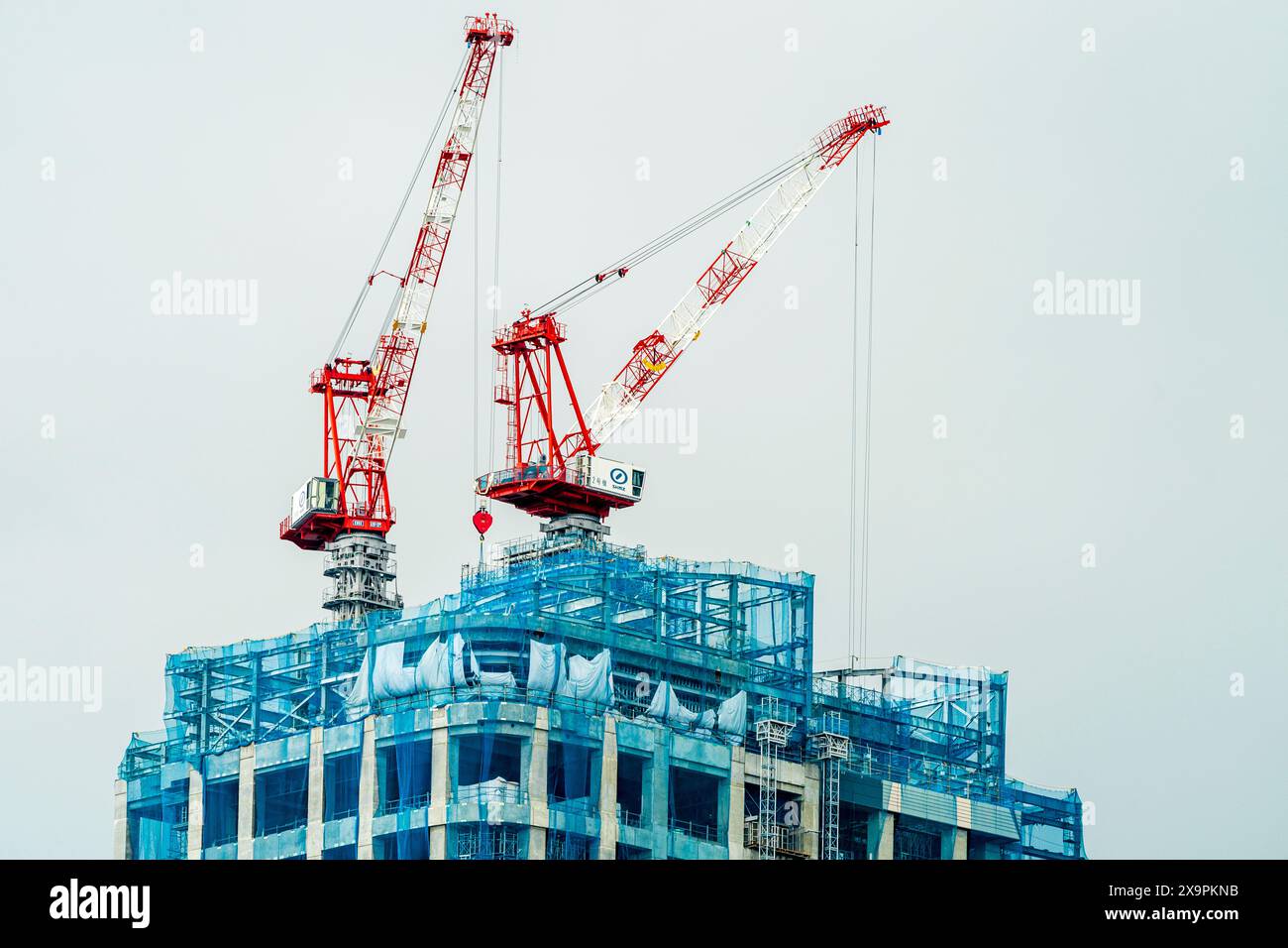 Crane on top skyscraper in hi-res stock photography and