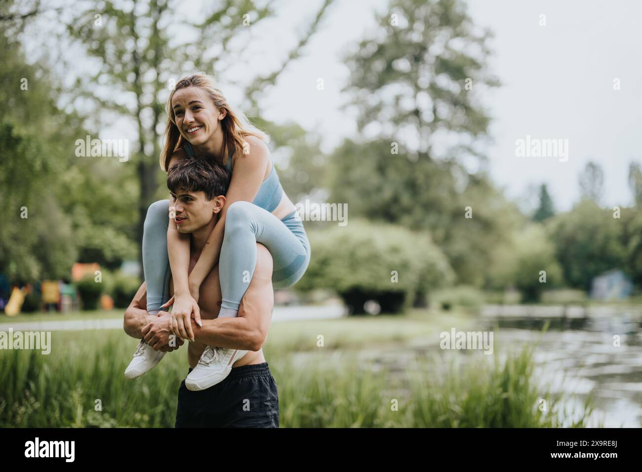 Happy couple enjoying piggyback ride outdoors on a bright day Stock ...