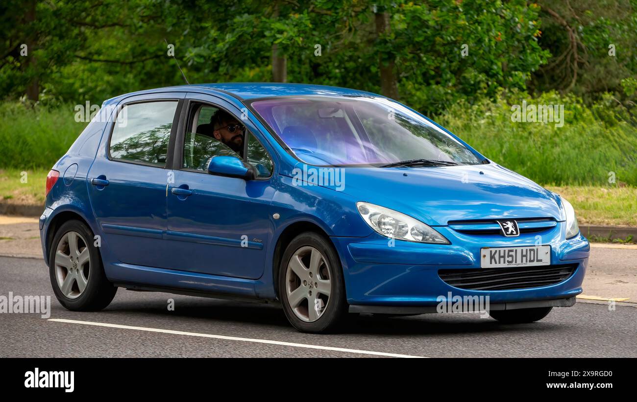 Milton Keynes,UK - May 27th 2024: 2002 blue Peugeot 307 car driving on a British road Stock Photo