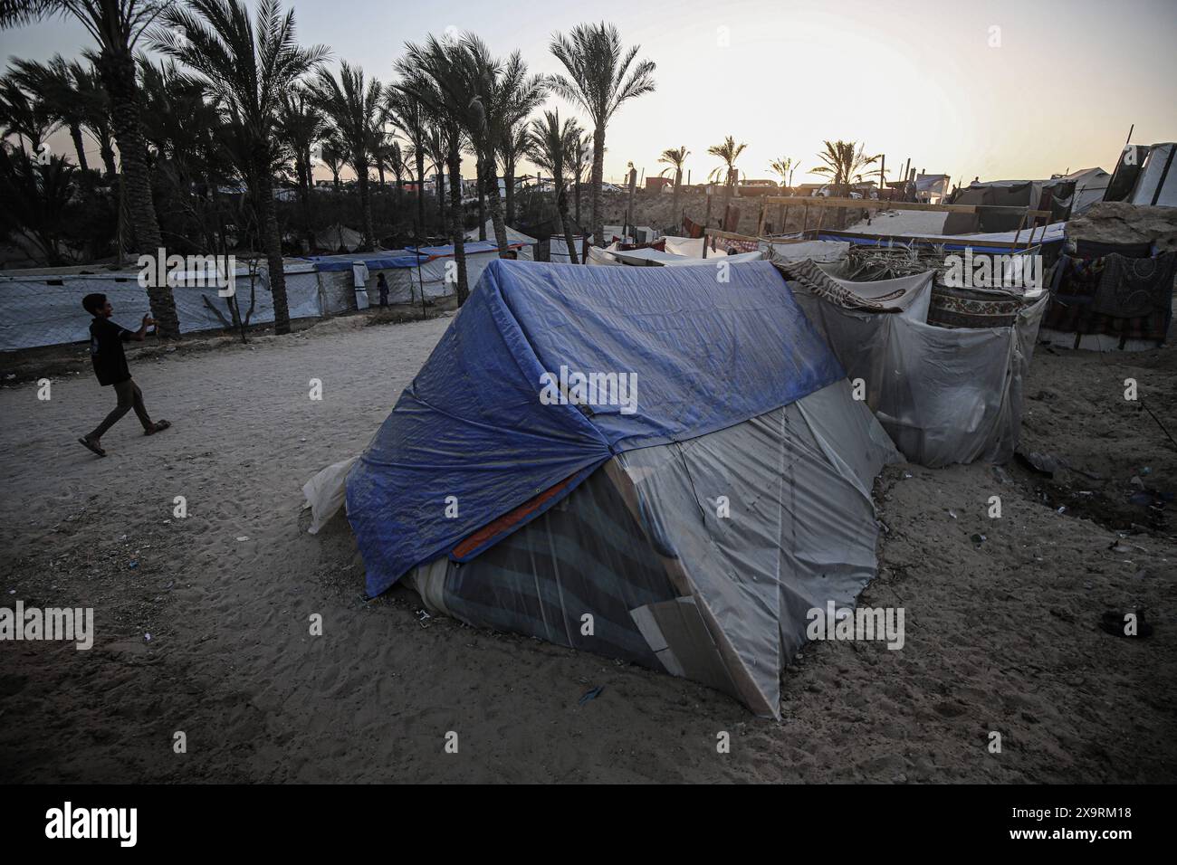Displaced Palestinians are being seen among the tents in Deir el-Balah ...