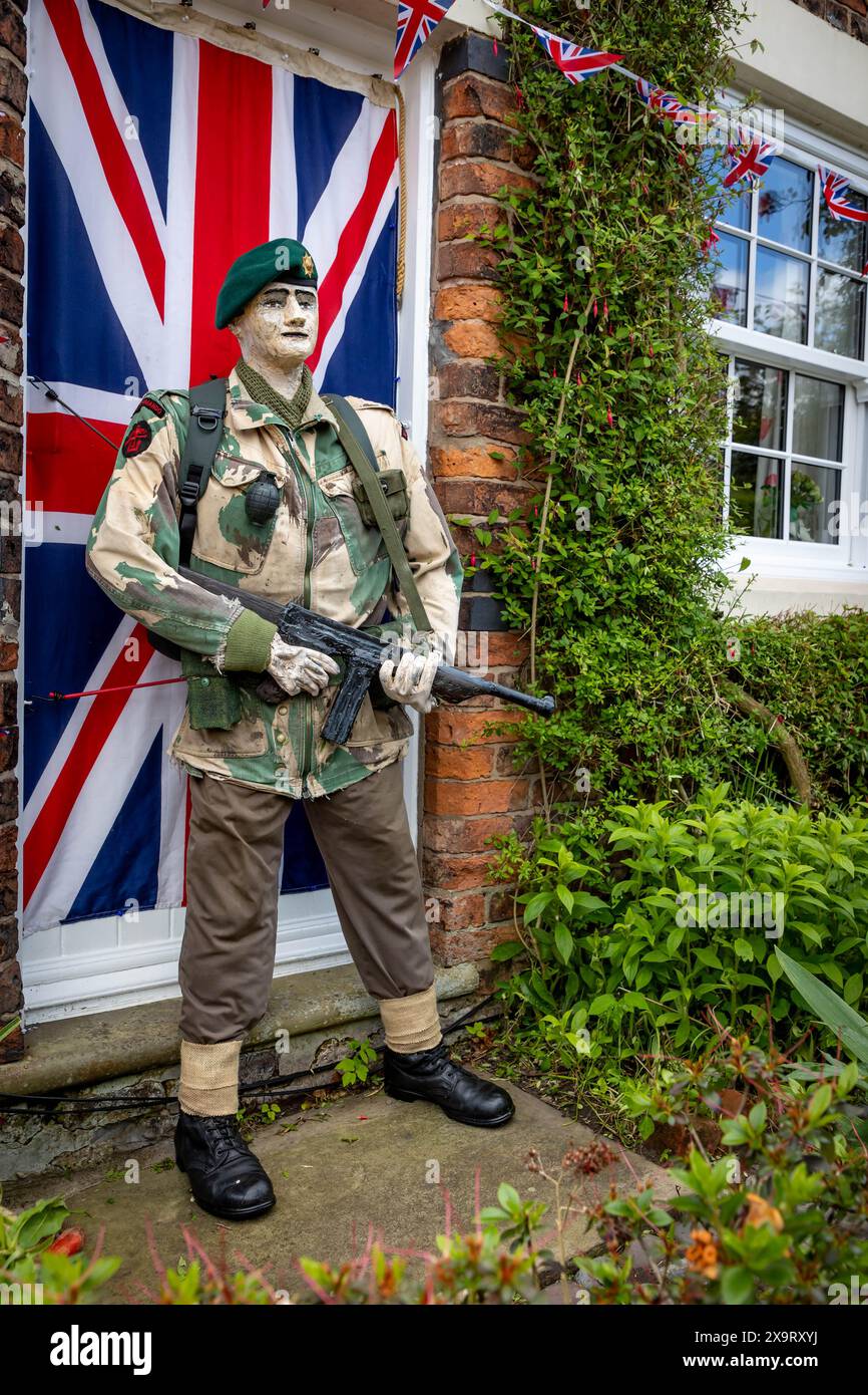 Daresbury Village, Cheshire, UK. 02nd June, 2024. Sergeant R Hough with 'Tommy' Gun, a Green Beret of No 3 Commando who was at Sword Beach on D-Day, represented by a scarecrow in the Daresbury Village Scarecrow Festival to commemorate the 80th anniversary of D-Day Credit: John Hopkins/Alamy Live News Stock Photo