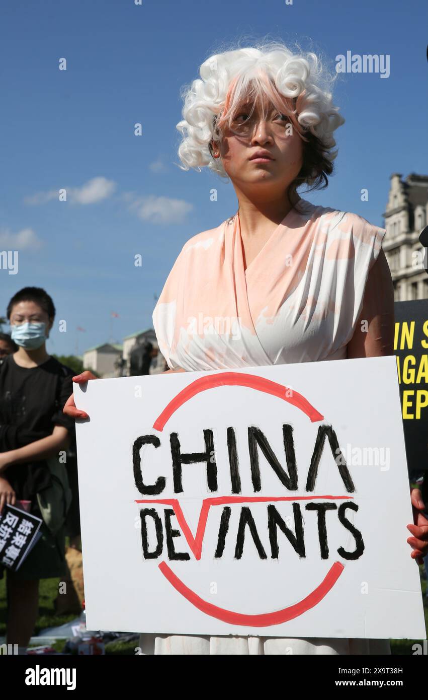 June 2, 2024, London, England, UK: A protester dressed as the Goddess of Democracy holds a sign supporting dissident group ''˜China Deviants' during the demonstration in Parliament Square. The event commemorated the1989 student-led protests and the Chinese government's bloody crackdown on 4 June, as well as protest against China's current clampdown on freedom of speech - including its increasing repression of Tibetans and Uyghurs, its crushing of dissent in Hong Kong, and the intimidation of Chinese and Hong Kong students in the UK, Europe and North America. Thirty-five years on, the Chinese Stock Photo