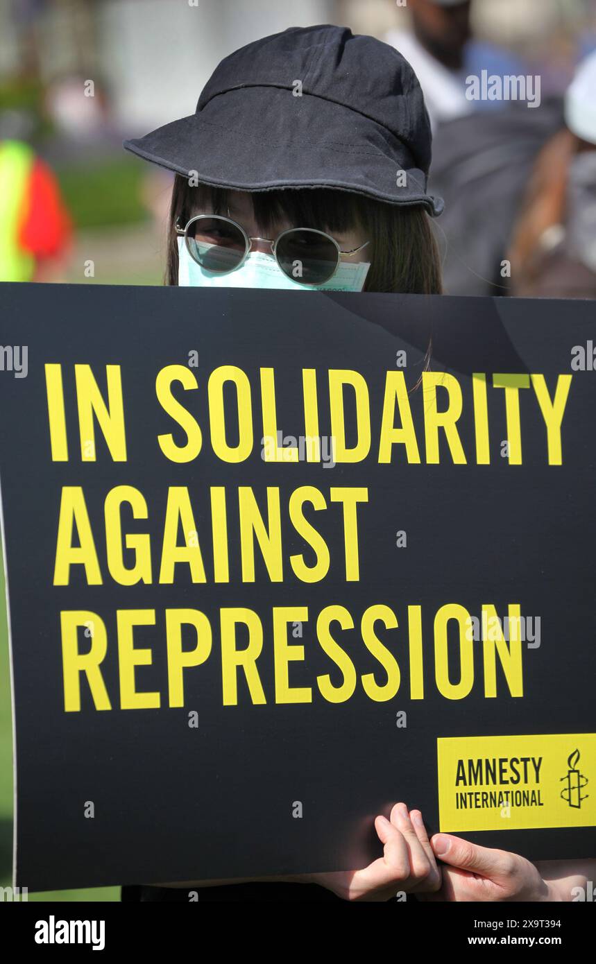 June 2, 2024, London, England, UK: A protester holds a sign saying ''˜In Solidarity Against Repression' during the demonstration in Parliament Square. The event commemorated the1989 student-led protests and the Chinese government's bloody crackdown on 4 June, as well as protest against China's current clampdown on freedom of speech - including its increasing repression of Tibetans and Uyghurs, its crushing of dissent in Hong Kong, and the intimidation of Chinese and Hong Kong students in the UK, Europe and North America. Thirty-five years on, the Chinese authorities still ban information rel Stock Photo