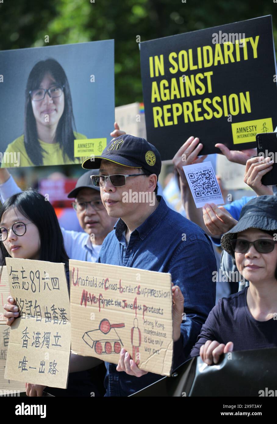 June 2, 2024, London, England, UK: Protesters gather together holding signs supporting their position, during the demonstration in Parliament Square. The event commemorated the1989 student-led protests and the Chinese government's bloody crackdown on 4 June, as well as protest against China's current clampdown on freedom of speech - including its increasing repression of Tibetans and Uyghurs, its crushing of dissent in Hong Kong, and the intimidation of Chinese and Hong Kong students in the UK, Europe and North America. Thirty-five years on, the Chinese authorities still ban information relate Stock Photo