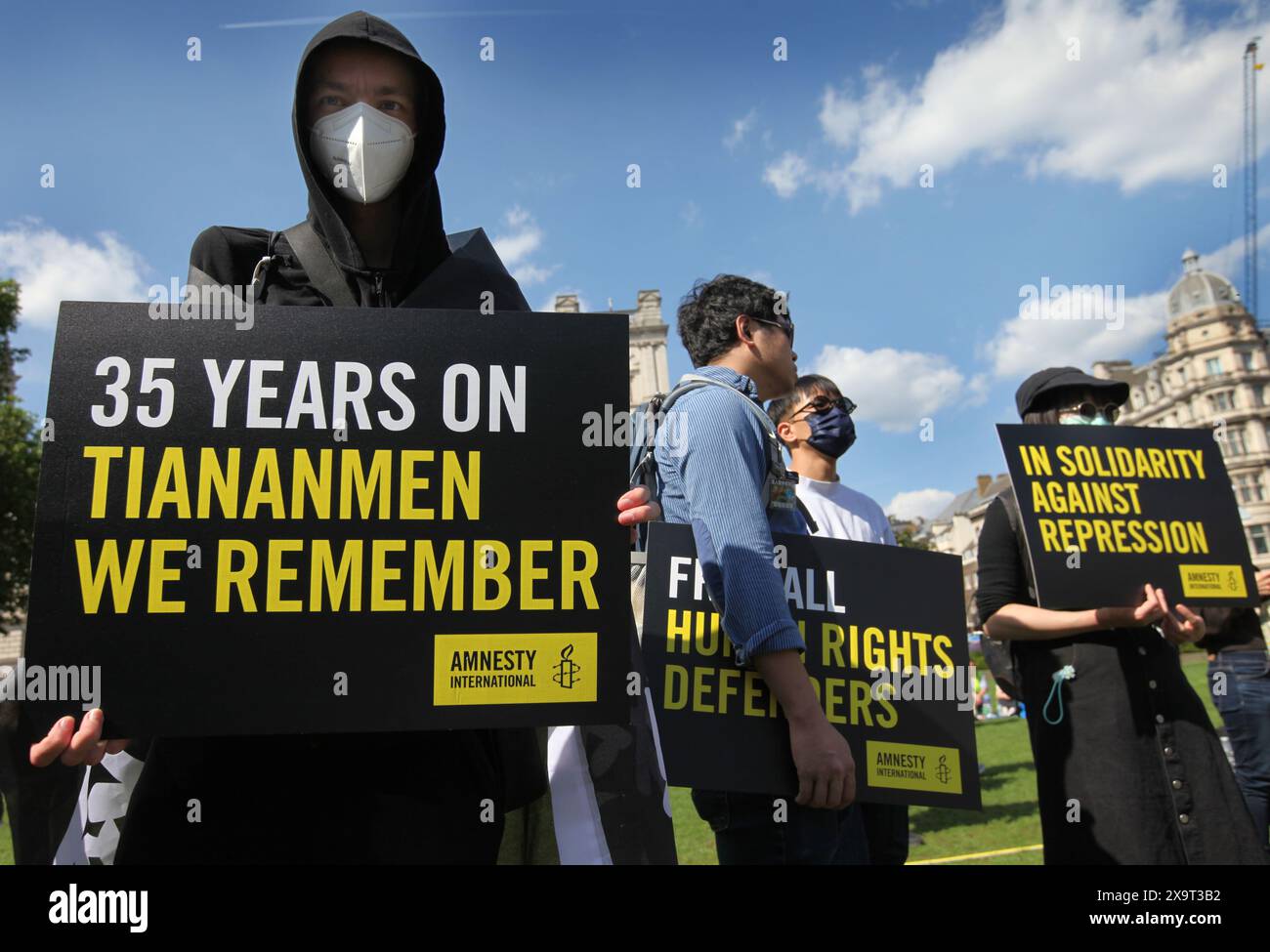 June 2, 2024, London, England, UK: Protesters hold signs supporting their position against the Chinese government during the demonstration in Parliament Square. The event commemorated the1989 student-led protests and the Chinese government's bloody crackdown on 4 June, as well as protest against China's current clampdown on freedom of speech - including its increasing repression of Tibetans and Uyghurs, its crushing of dissent in Hong Kong, and the intimidation of Chinese and Hong Kong students in the UK, Europe and North America. Thirty-five years on, the Chinese authorities still ban informa Stock Photo